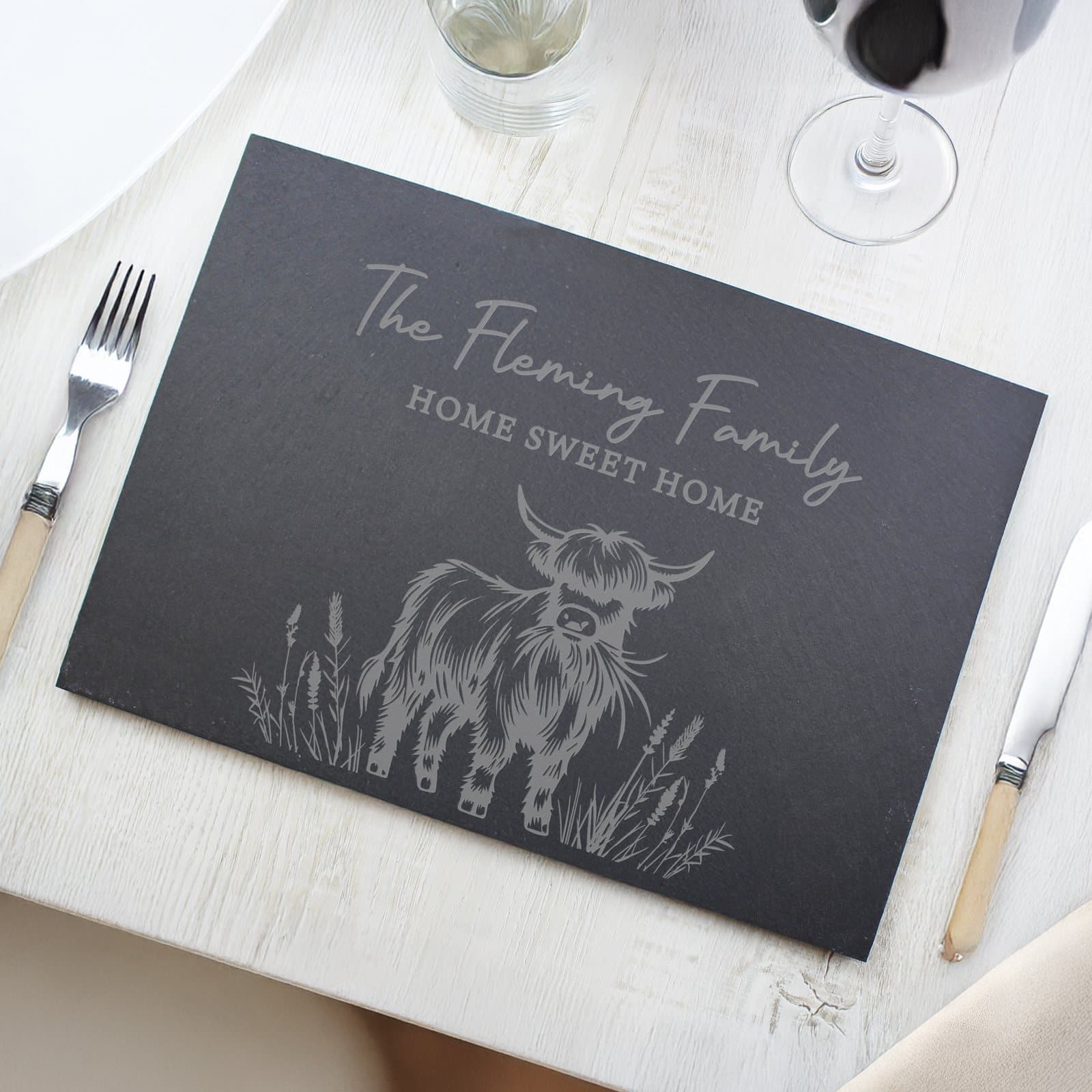 Hand-cut slate placemat with a Highland cow design and personalised lines
