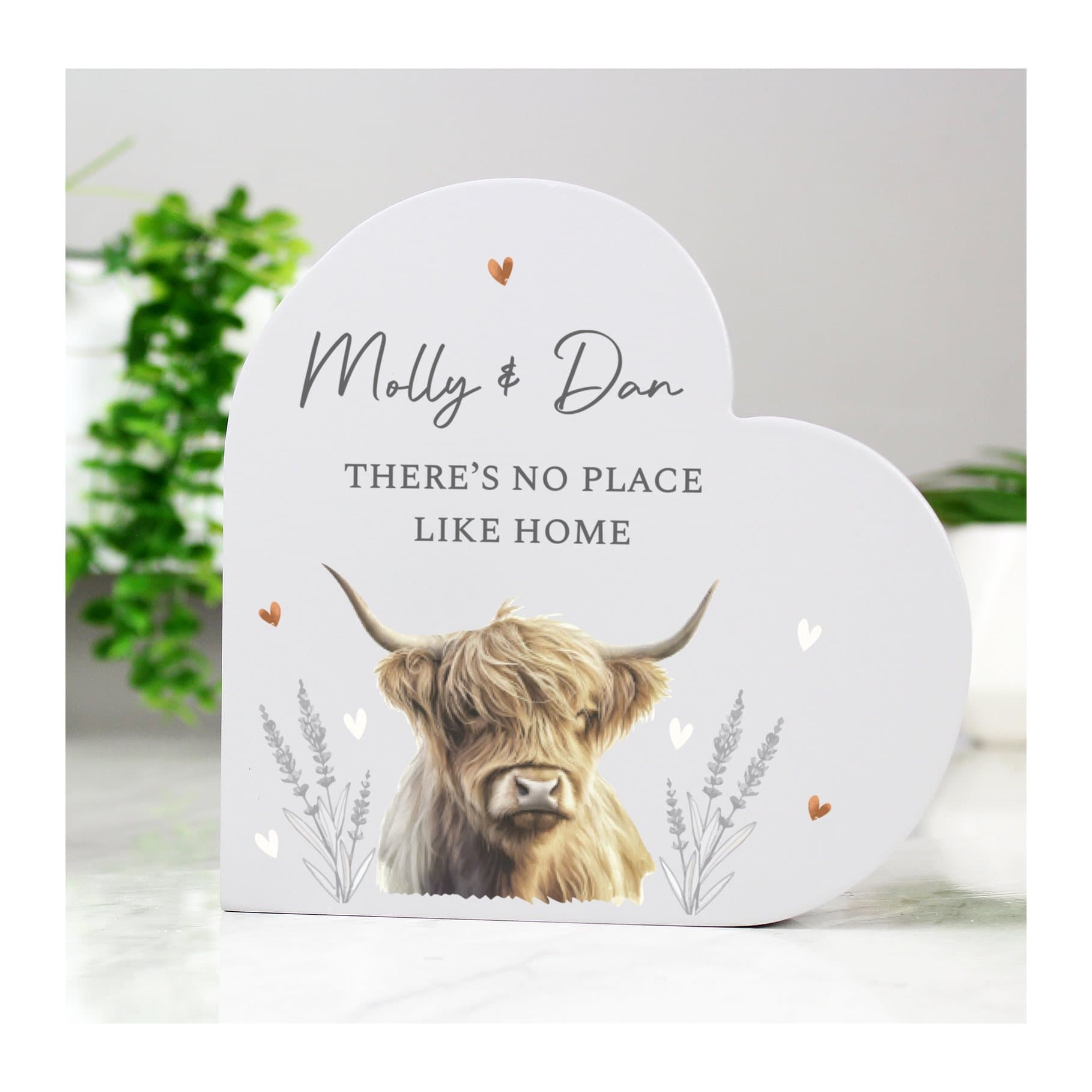 Grey wooden heart ornament with a Highland cow illustration and message lines