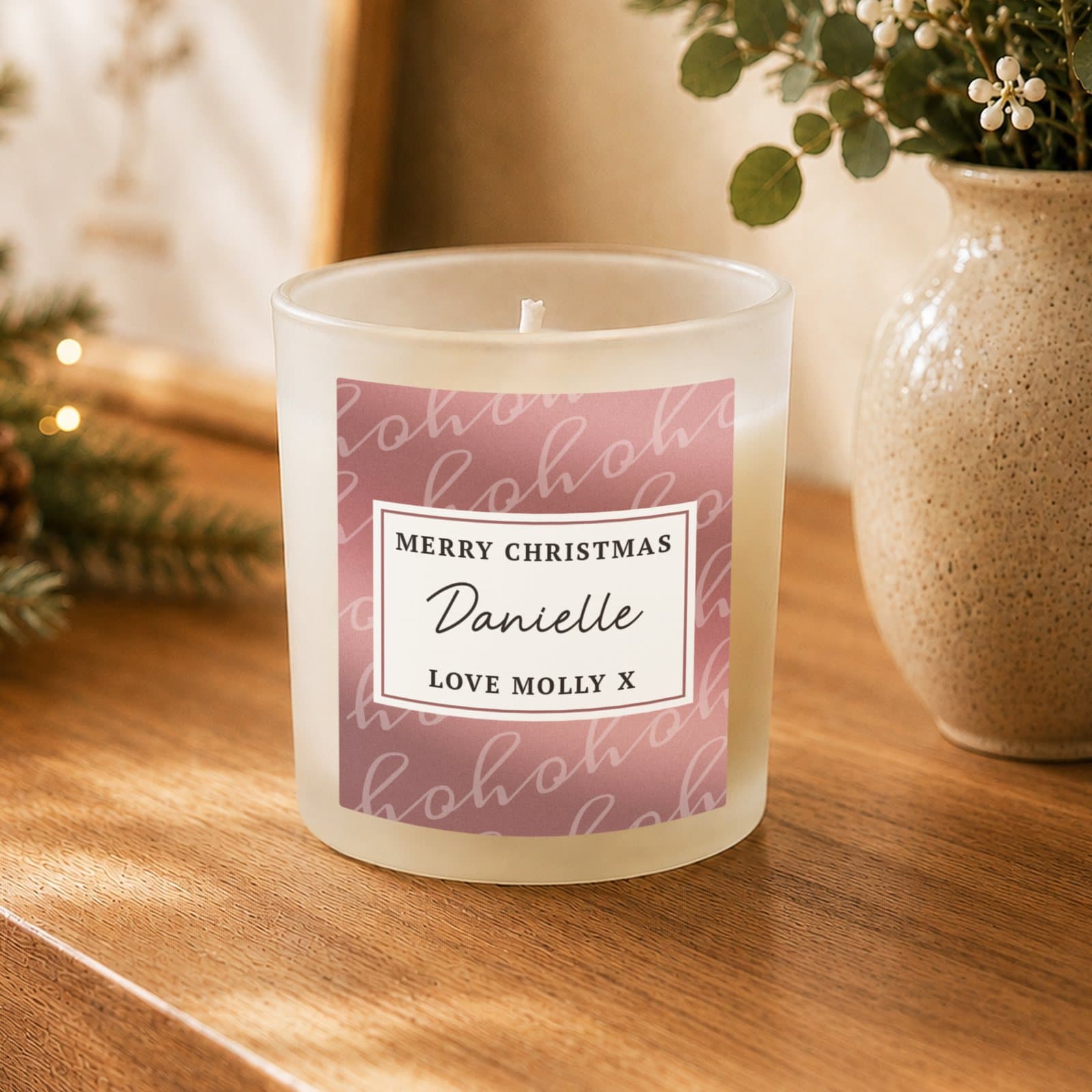 Glass candle jar with a dusky pink Ho Ho Ho label