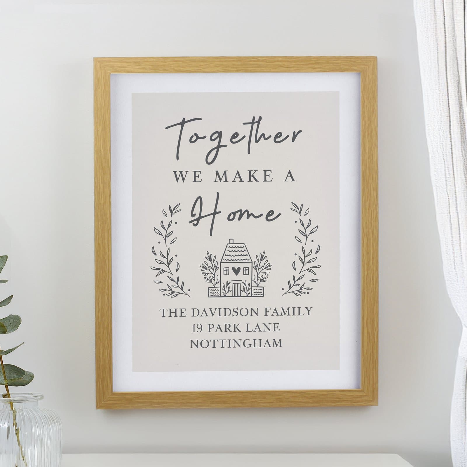 Oak framed print reading Together WE MAKE A home with personalised lines