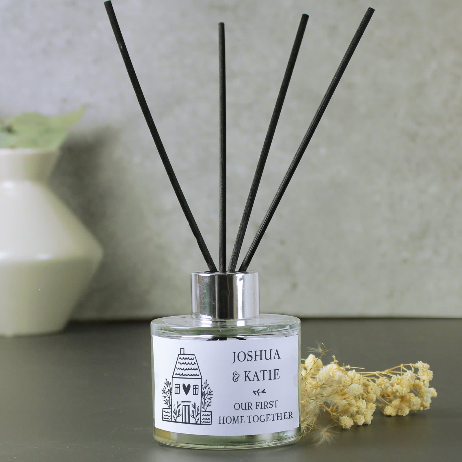 Personalised HOME reed diffuser in a glass bottle with reeds