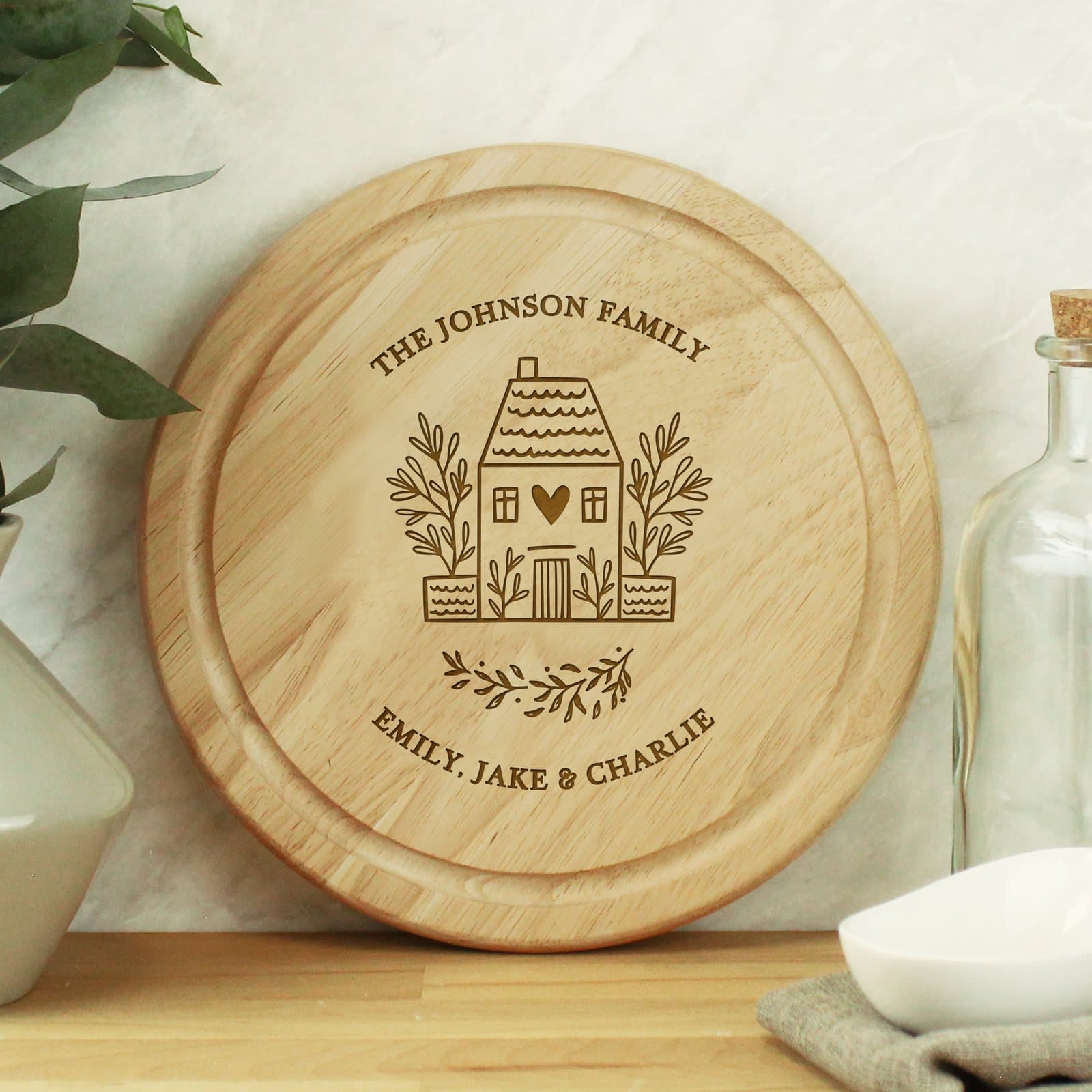 Round wooden chopping board with HOME text and two lines of personalisation