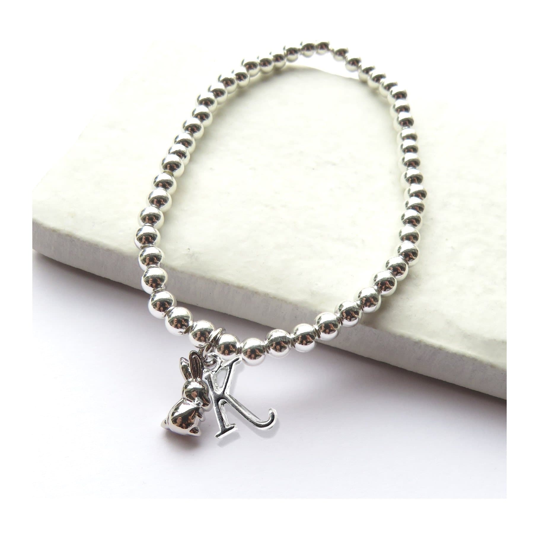 Stretch beaded bracelet with a silver plated bunny rabbit charm and an initial
