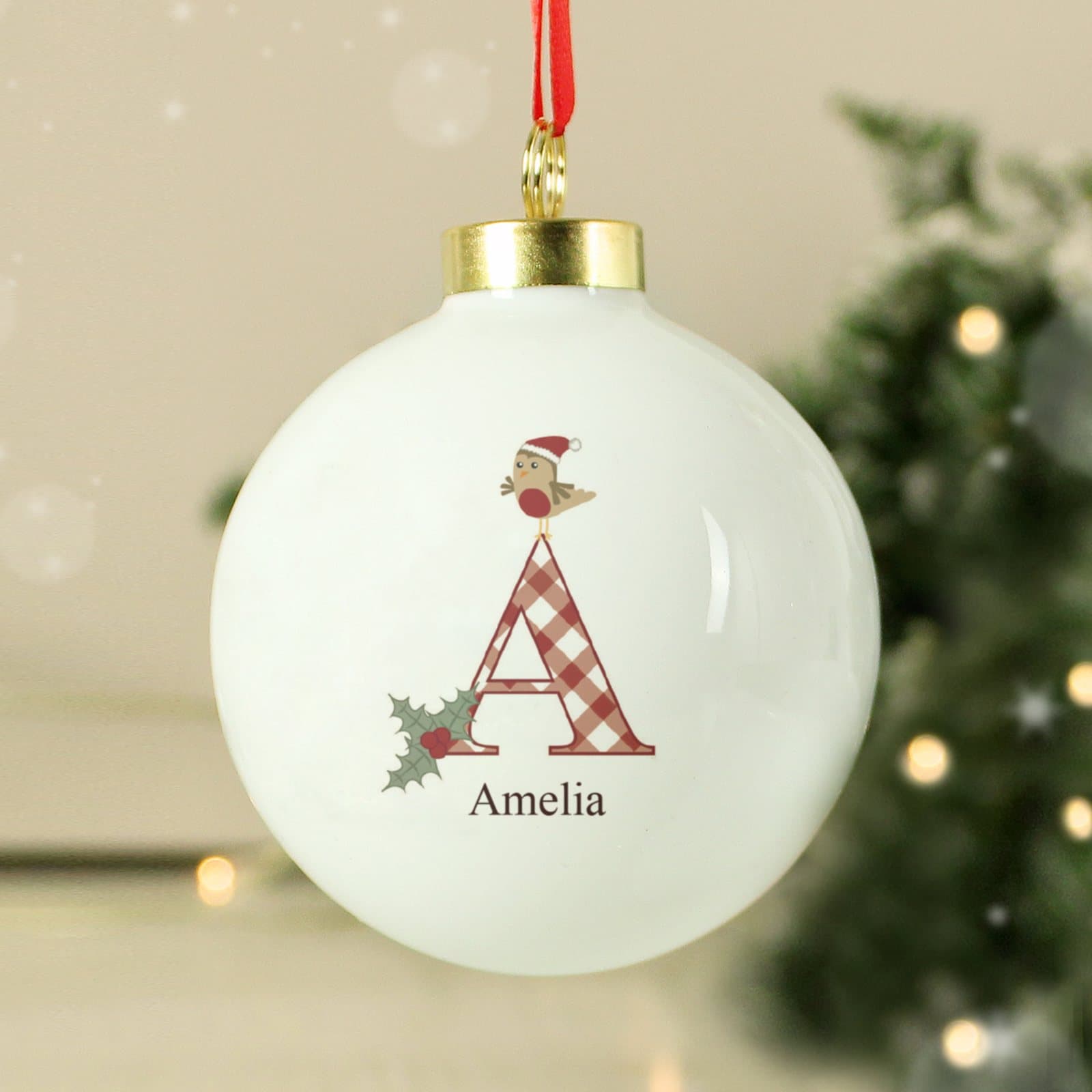 Personalised ceramic robin Christmas bauble with a red ribbon