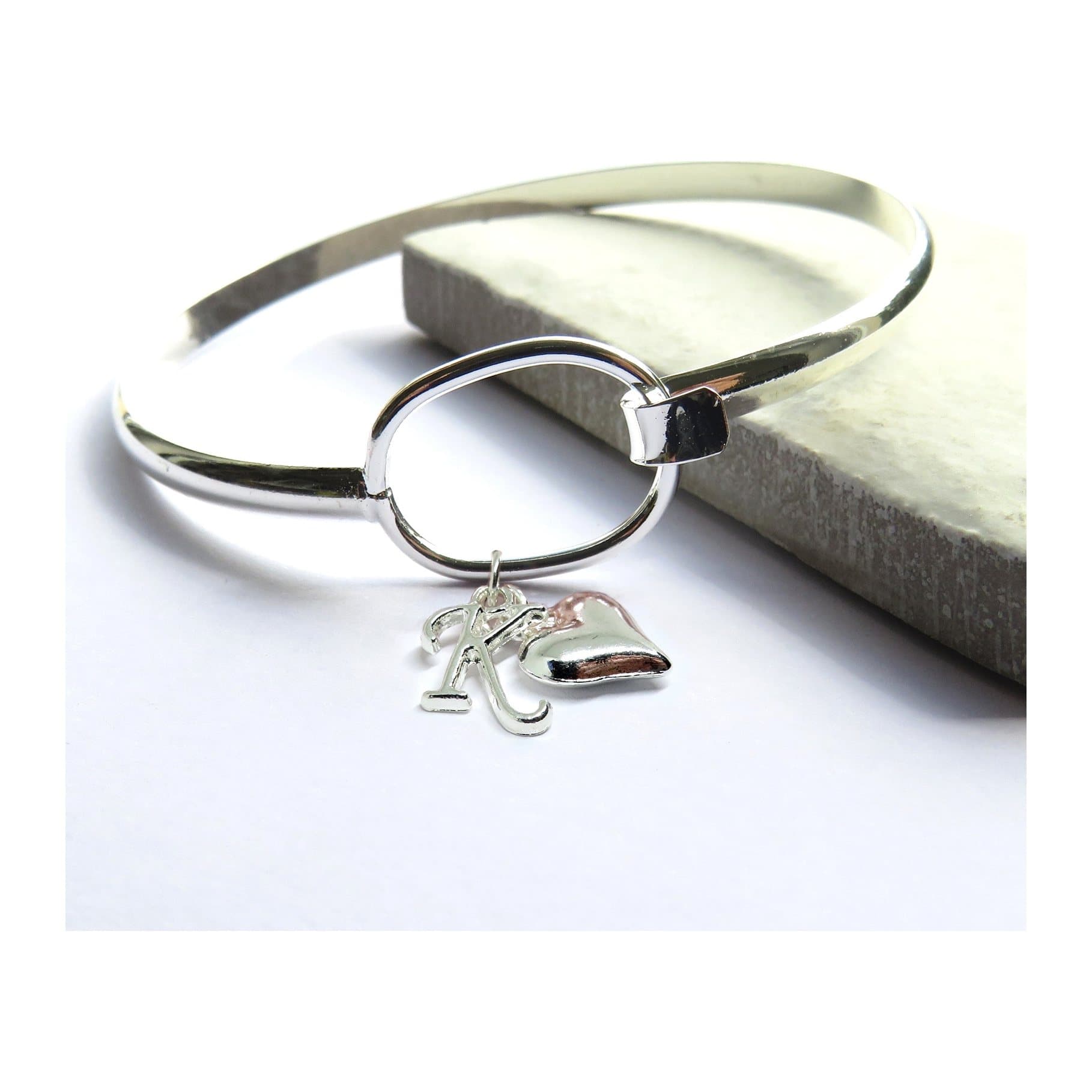 Silver plated loop bangle with a heart charm and a personalised initial
