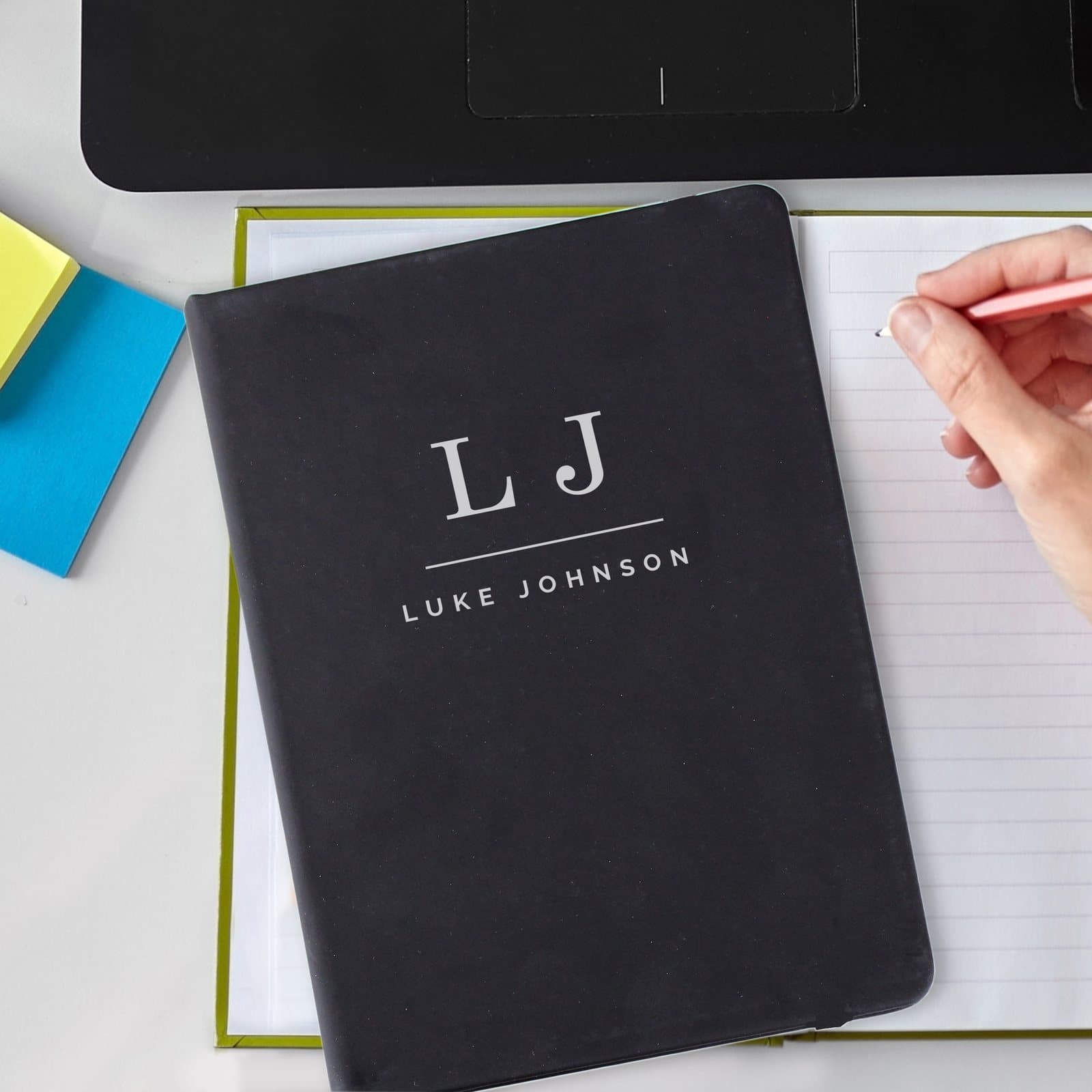 Personalised black A5 hardback notebook with initials and a message line