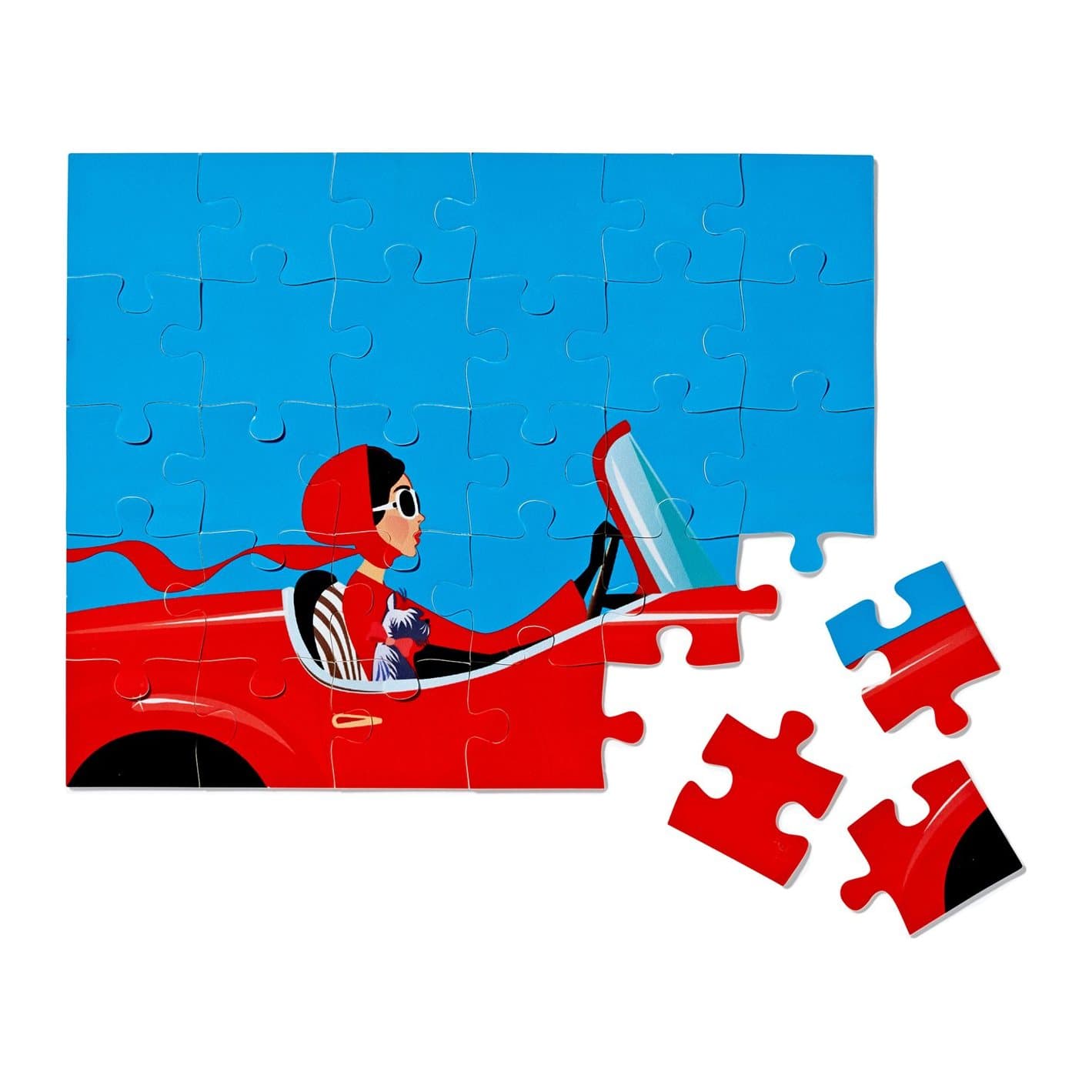 Finished 30 piece jigsaw of a girl driving a red car, with pieces beside it