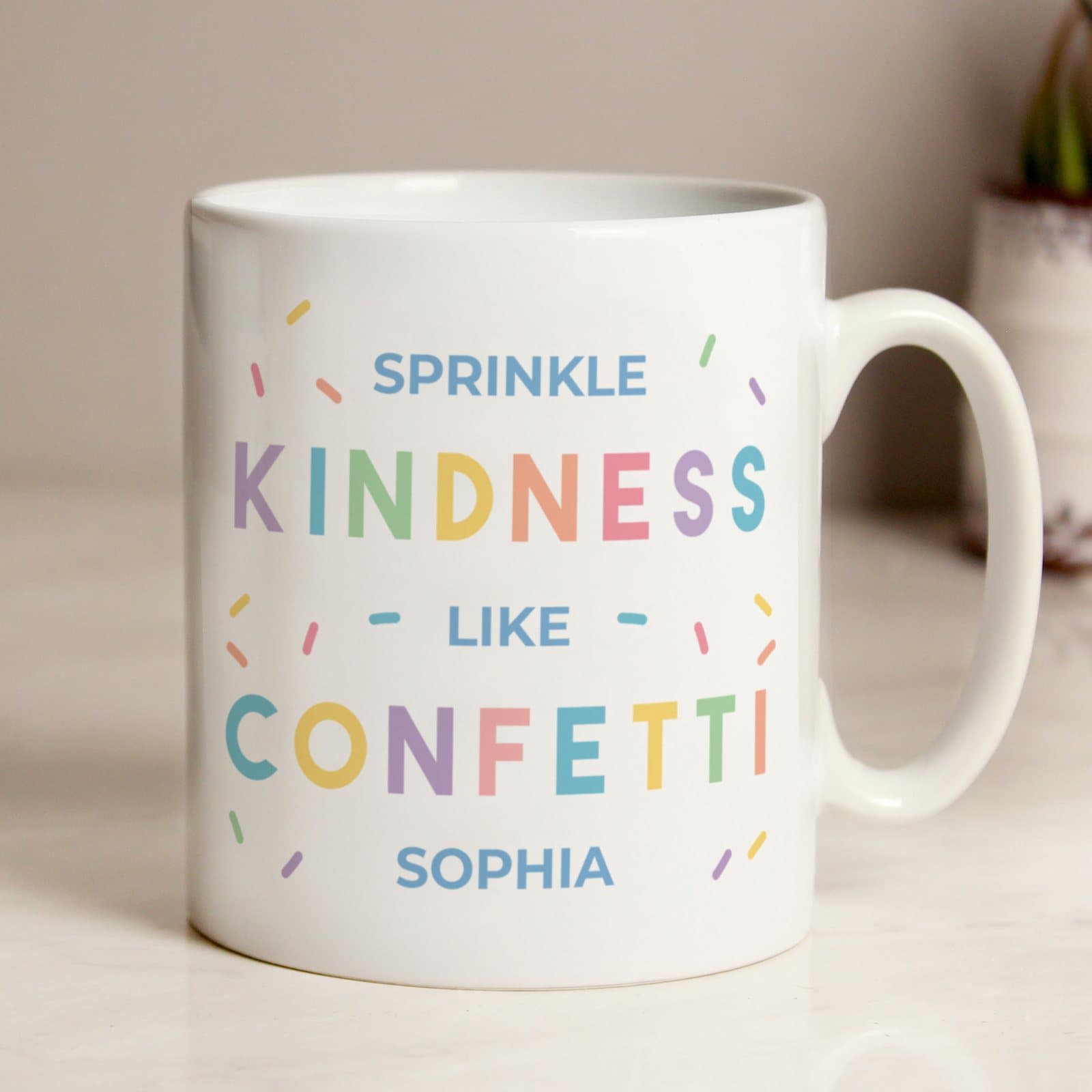 Ceramic mug printed with Sprinkle kindness like confetti and a name