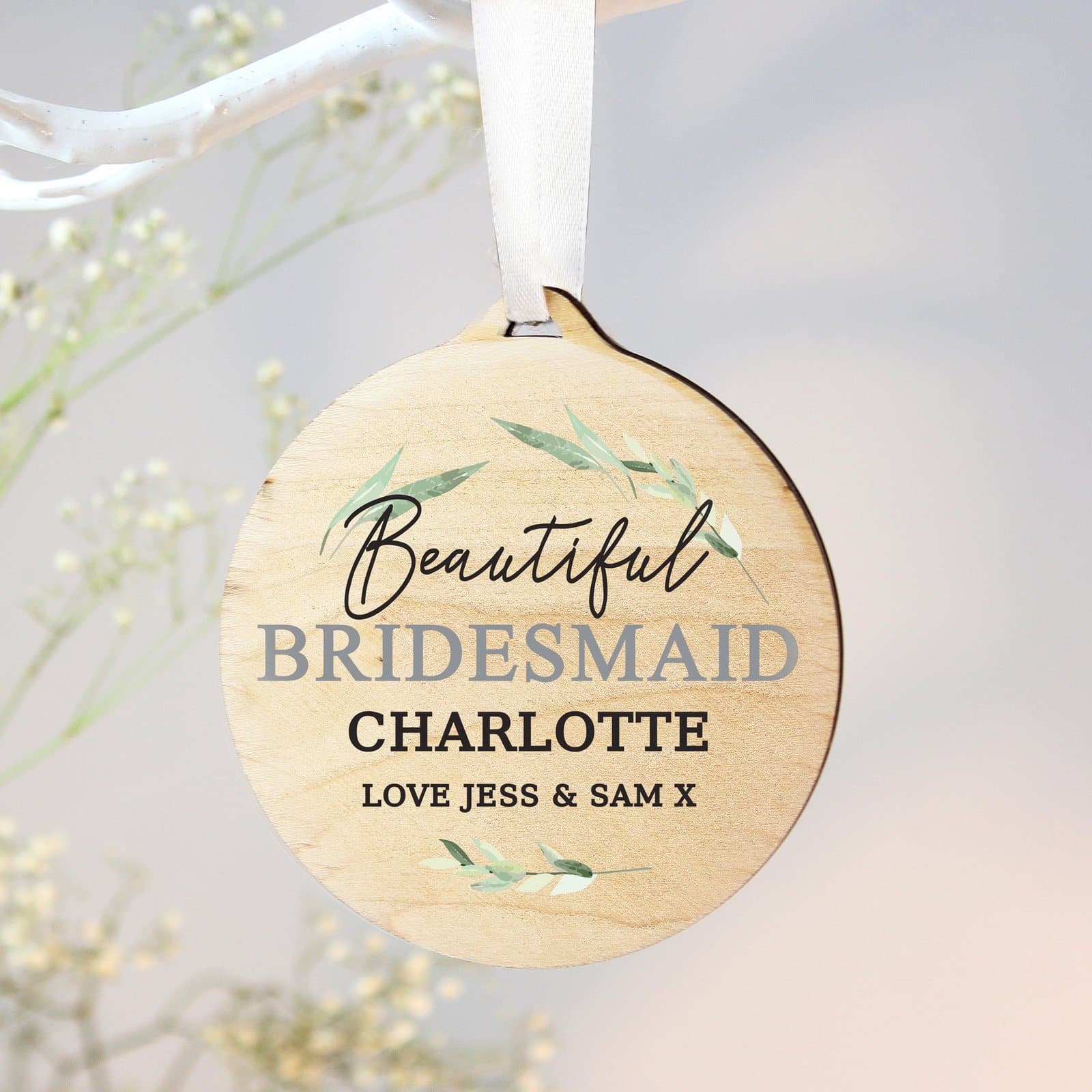 Round wooden decoration with ribbon and four lines of text