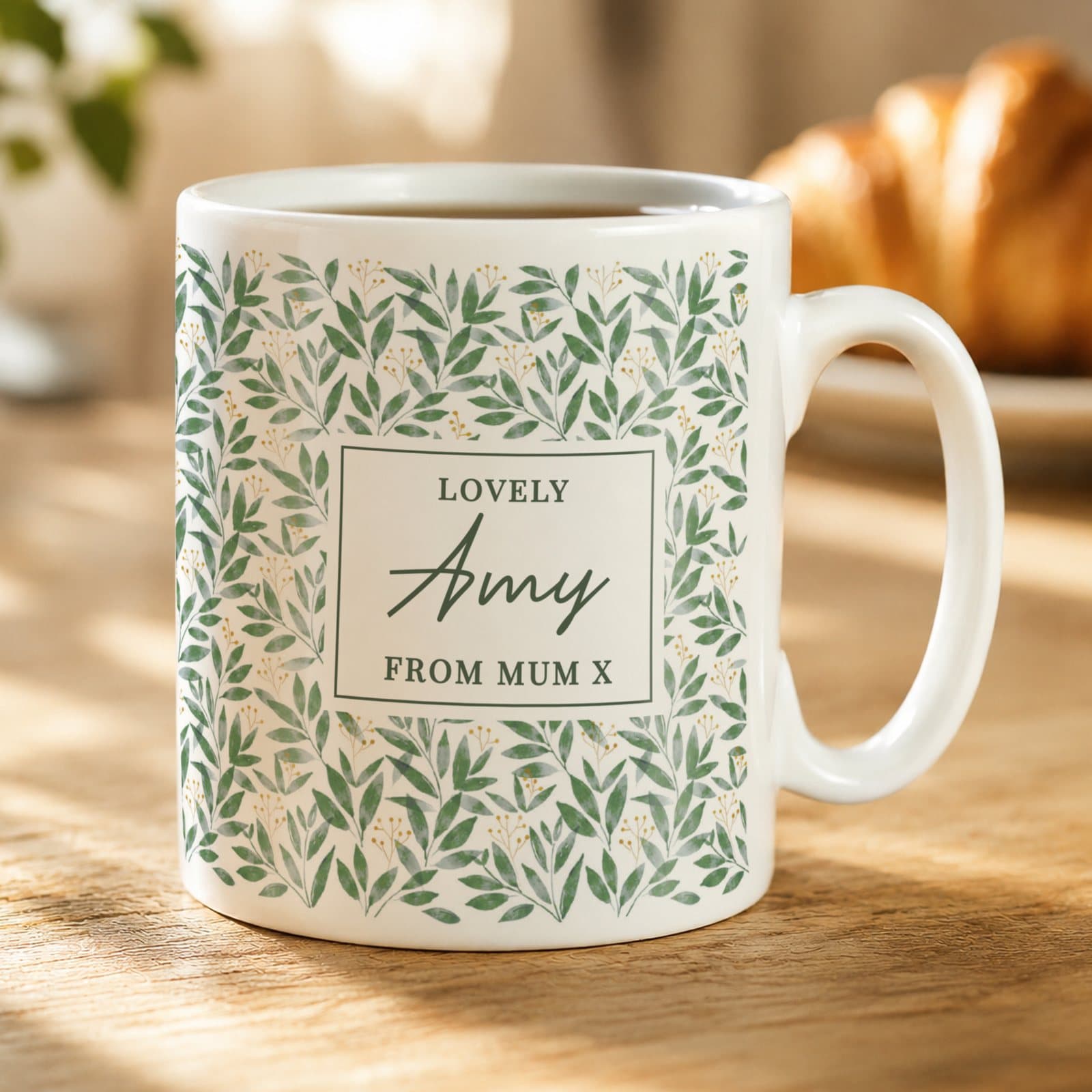 Ceramic mug with a bold green leaves design and three lines of text