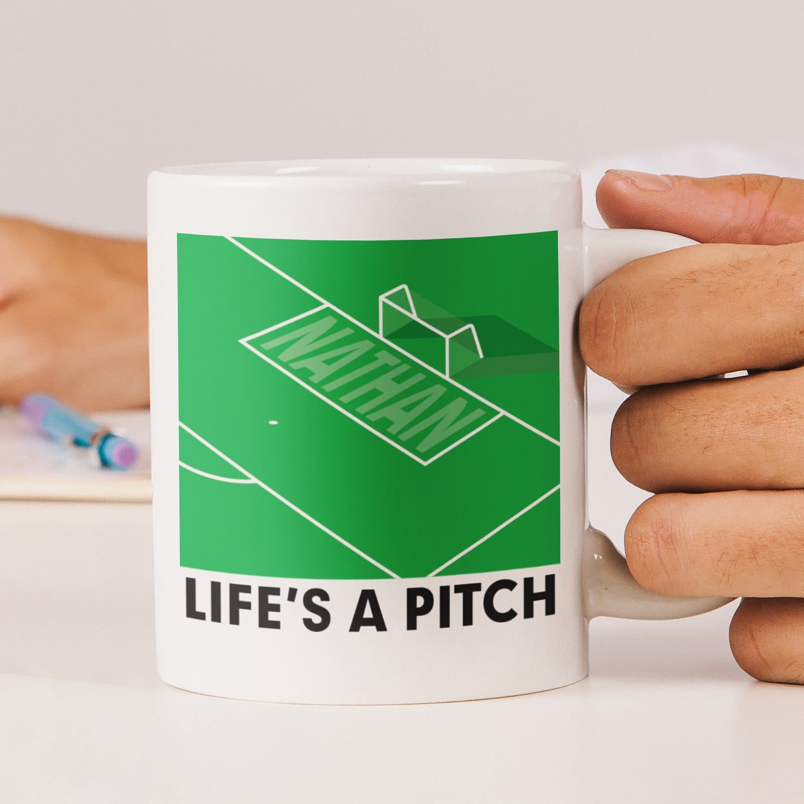 Ceramic mug printed with the football pun Life's a pitch and a name