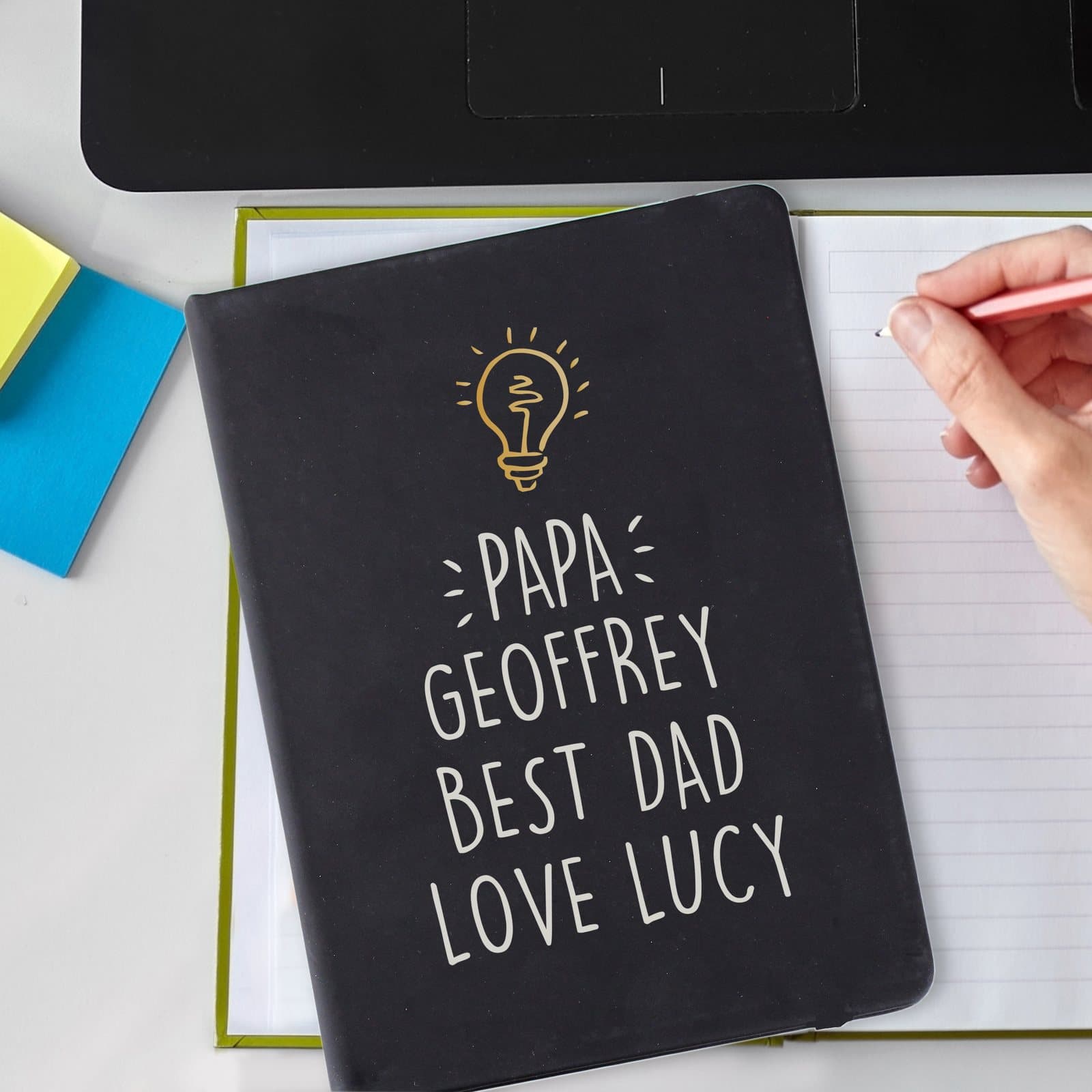 Black hardback notebook with light bulb design
