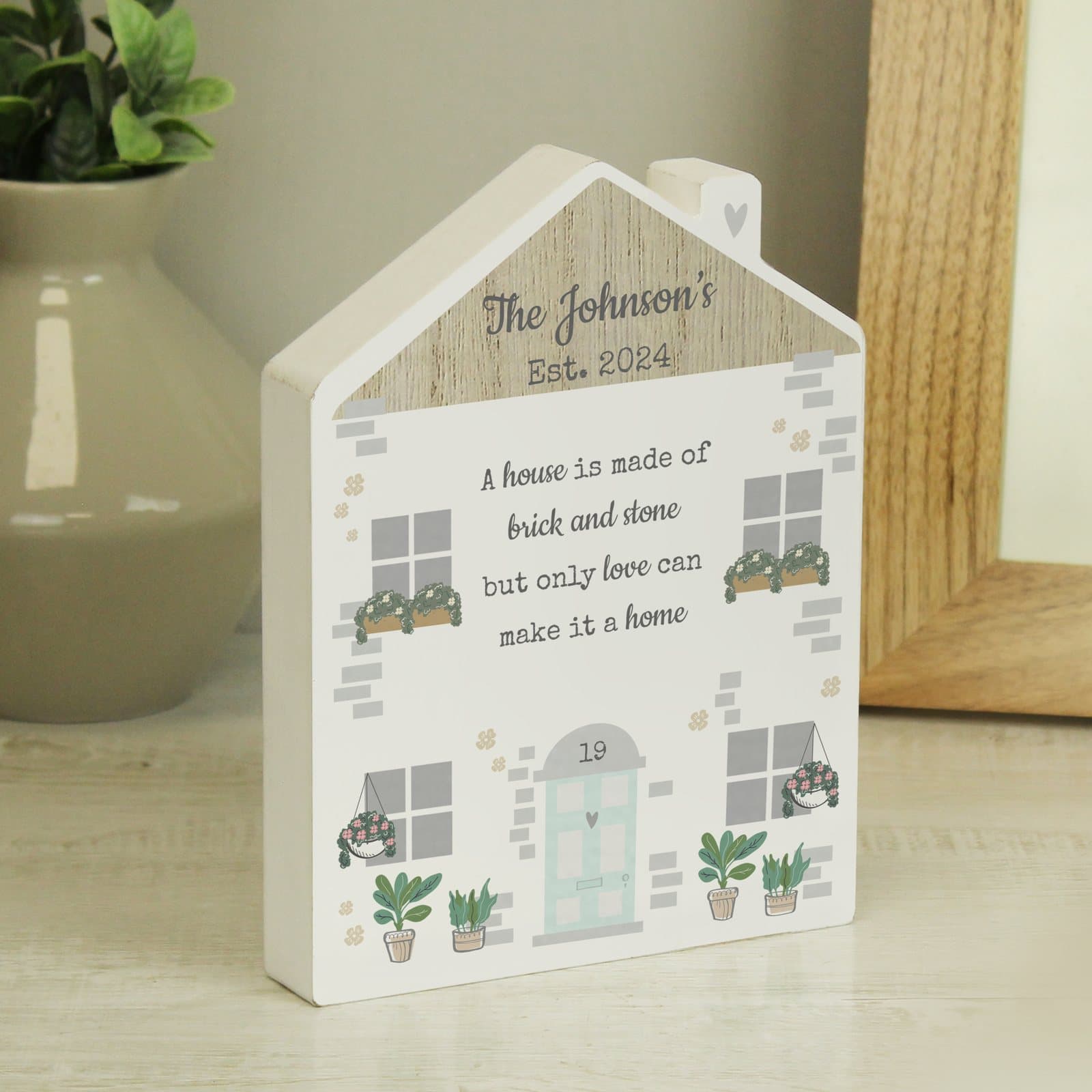 Free-standing wooden house ornament with a personalised message and door number