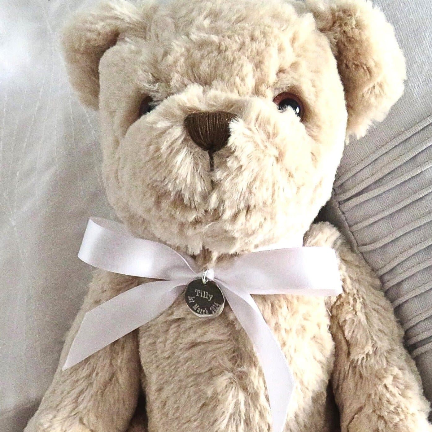 Luxury teddy bear with an engraved stainless steel charm and ribbon