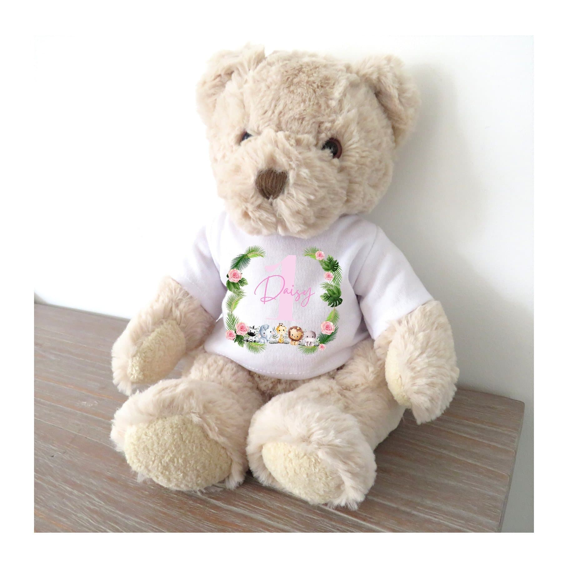 Luxury teddy bear wearing a T-shirt with five animals, greenery and pink flowers