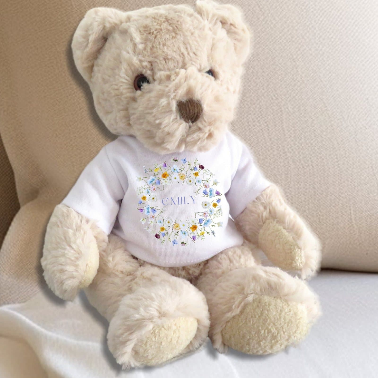 Teddy bear in a t-shirt with spring flowers in yellow, purple, cream and pink