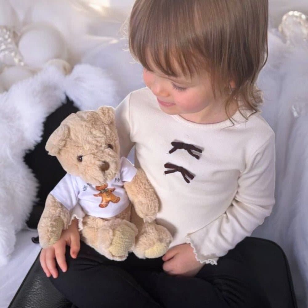 Teddy bear in a T-shirt with Santa on his sleigh and a First Christmas 2026 design