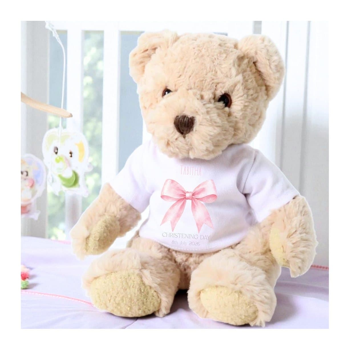 Personalised teddy bear wearing a T-shirt with a pink bow printed on it