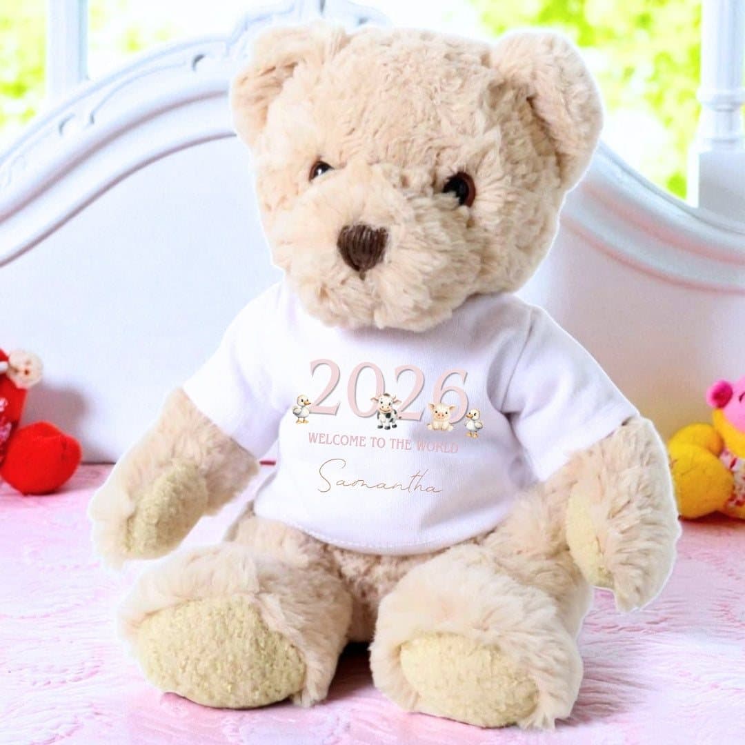 Teddy bear with a printed T-shirt of cute farm animals and 2026 Welcome to the World
