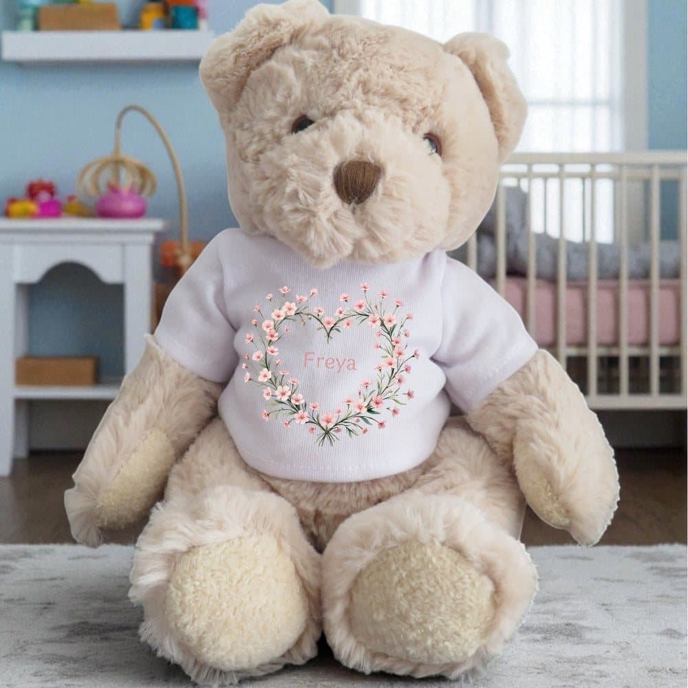 Personalised teddy bear in a printed T-shirt with pink flowers in a heart shape