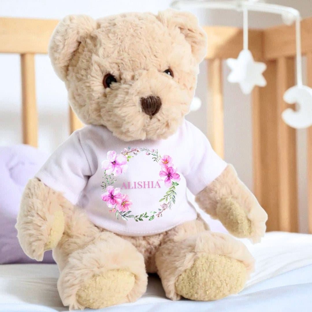 Teddy bear wearing a T-shirt with a pink flower wreath design