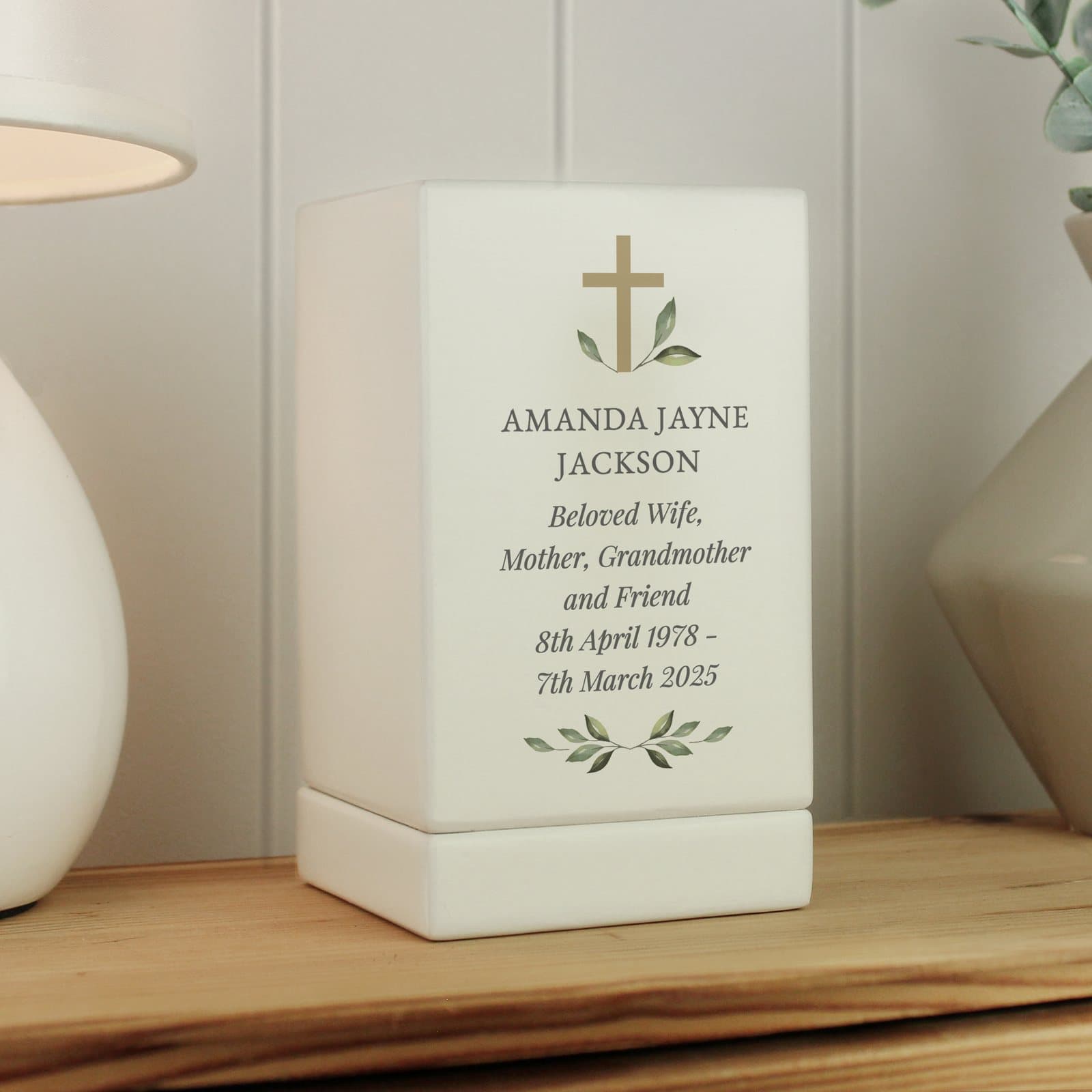 Small wooden memorial urn with a cross design and personalised text