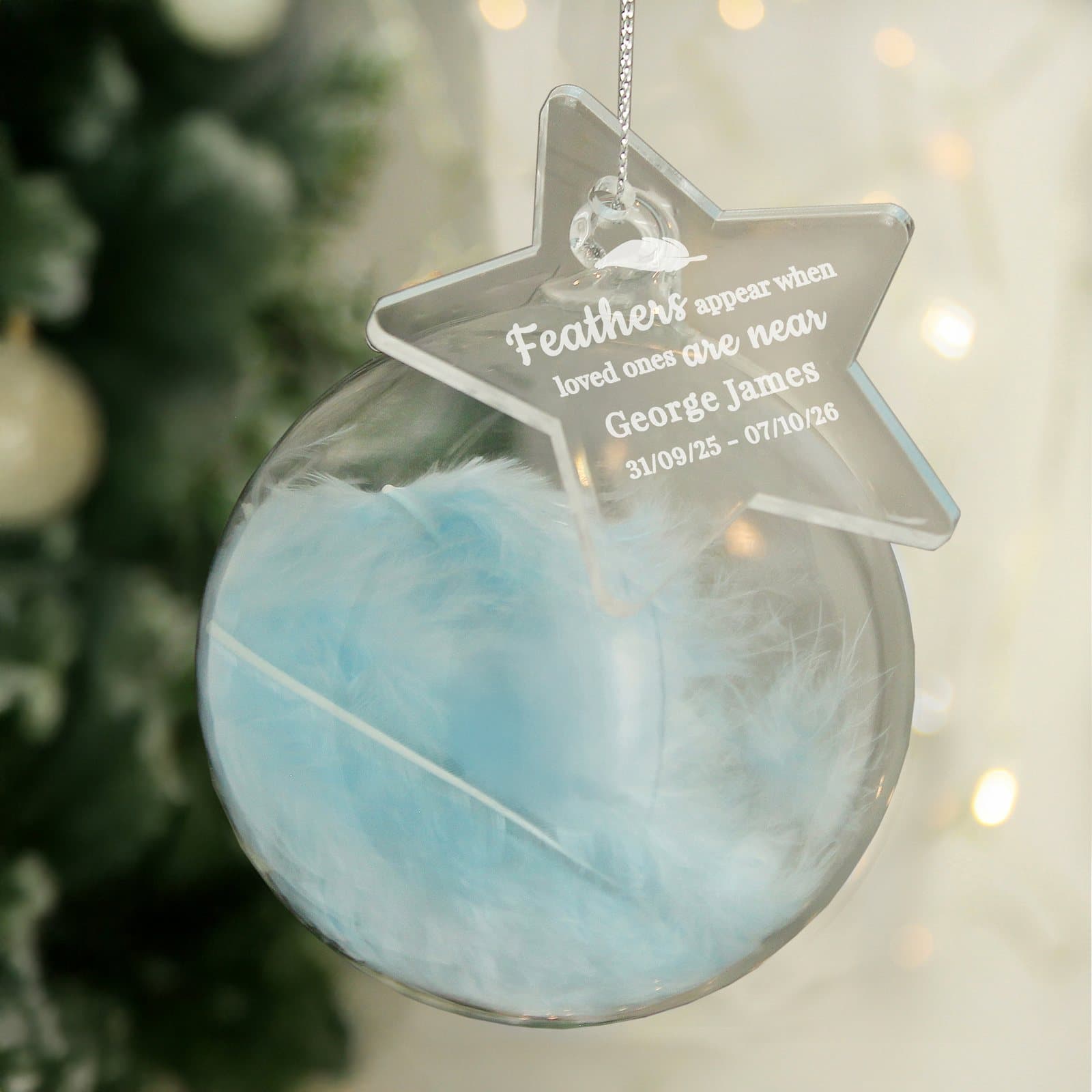 Glass bauble filled with a feather and an acrylic tag with memorial text