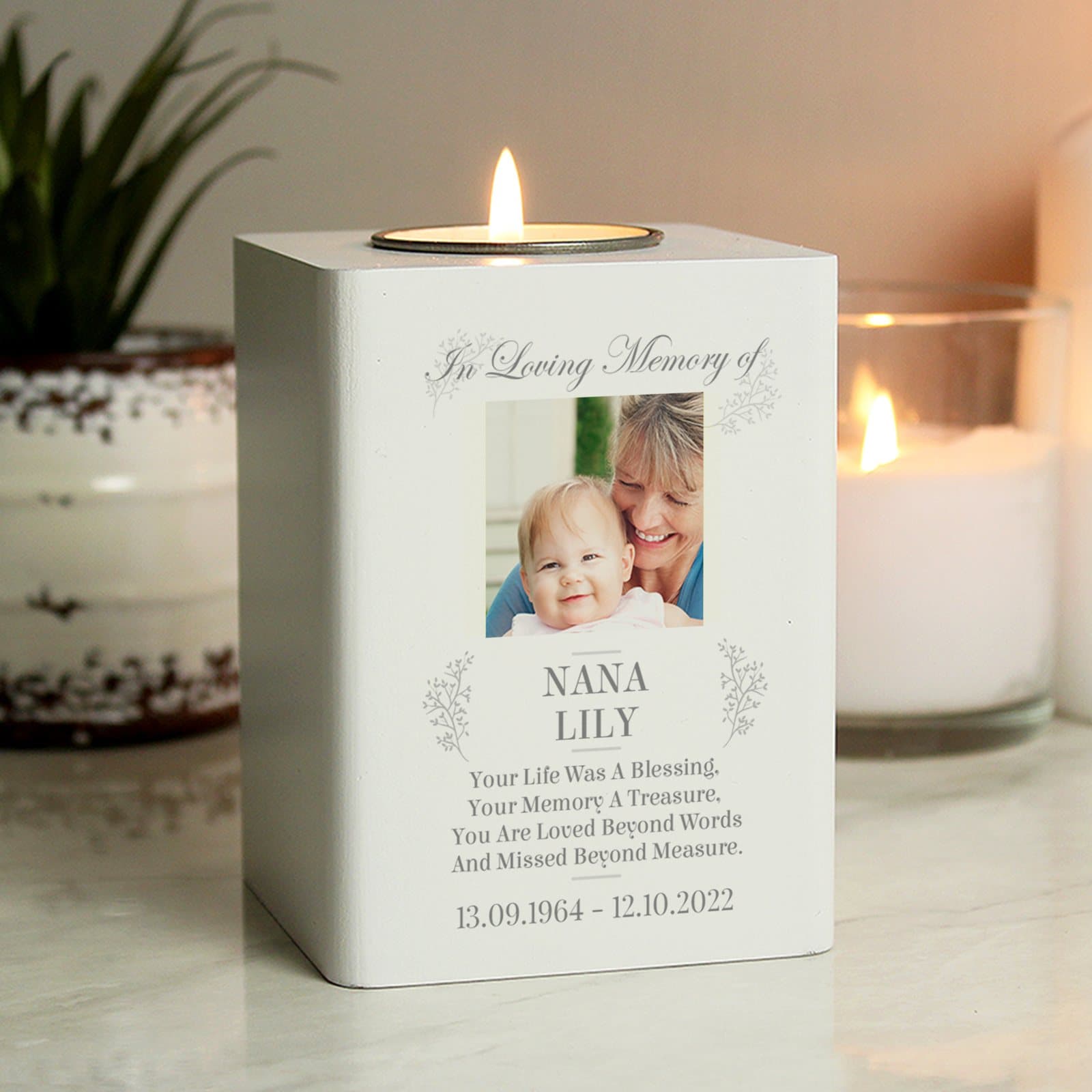 White wooden memorial tea light holder with a photo, names and a date