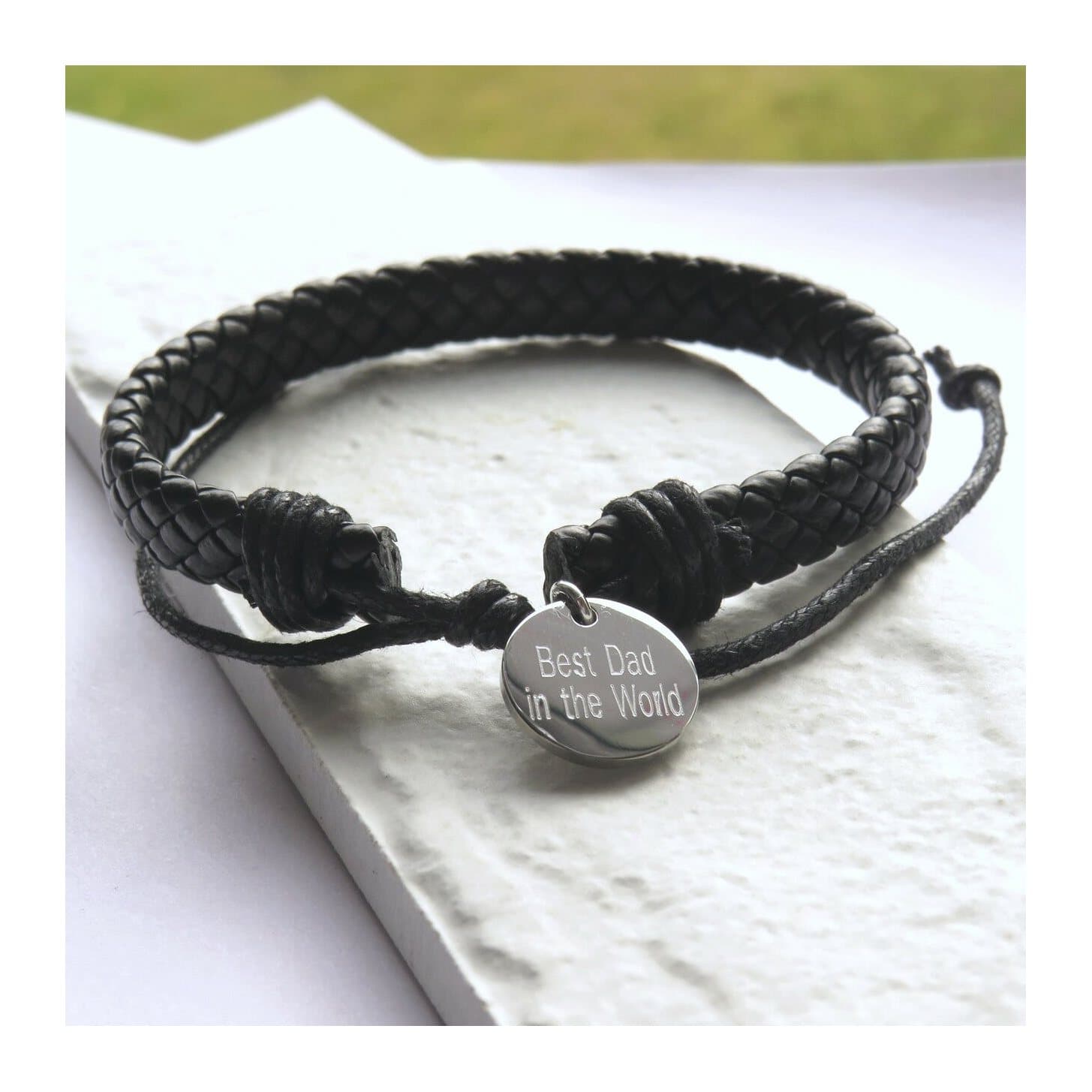 Black imitation leather weave bracelet with a stainless steel disc