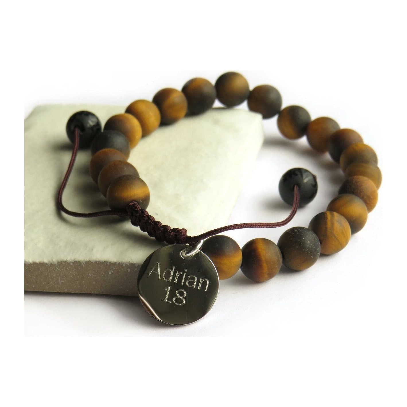 Tiger's eye bead bracelet on nylon thread with a stainless steel disc