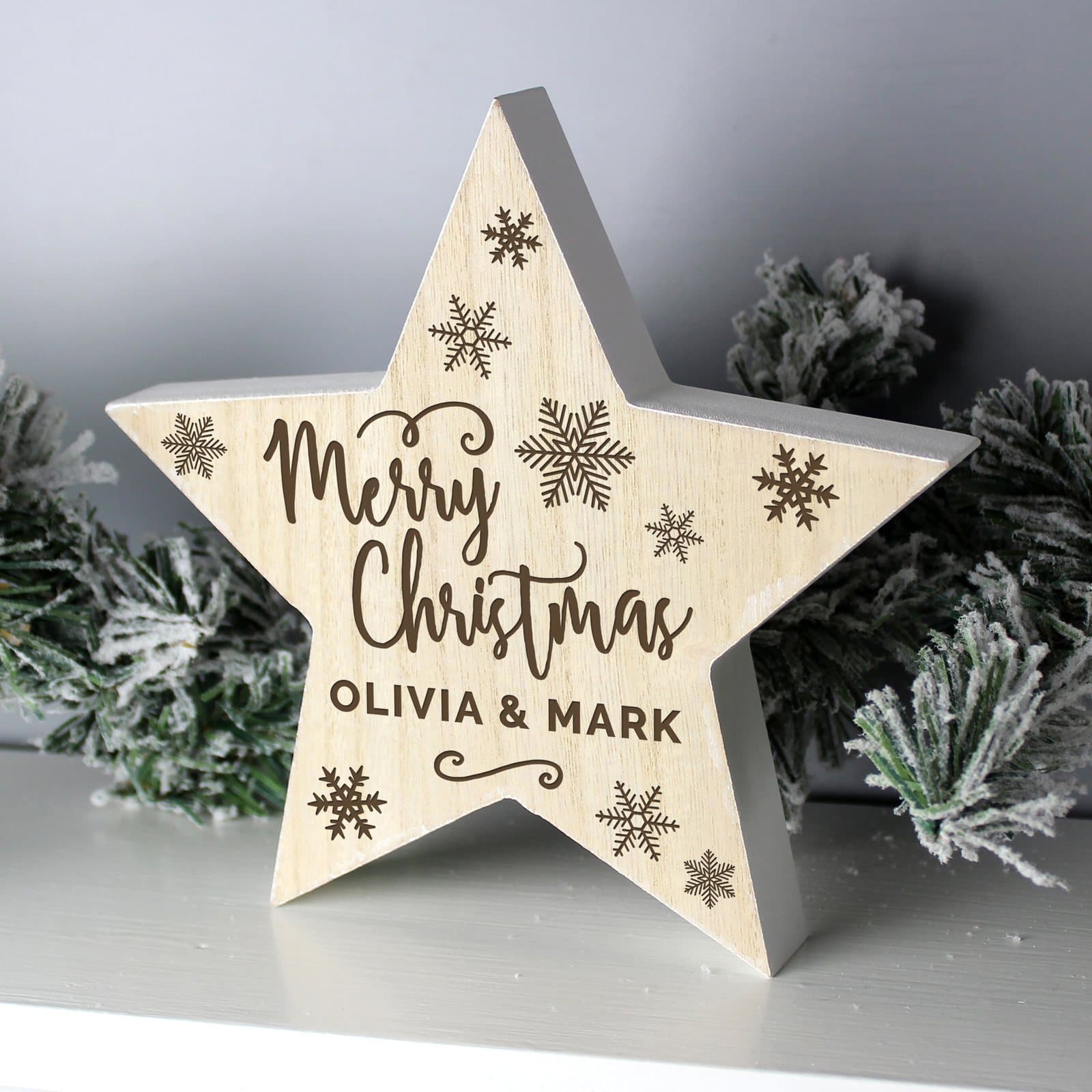 Rustic wooden star decoration reading Merry Christmas with a name