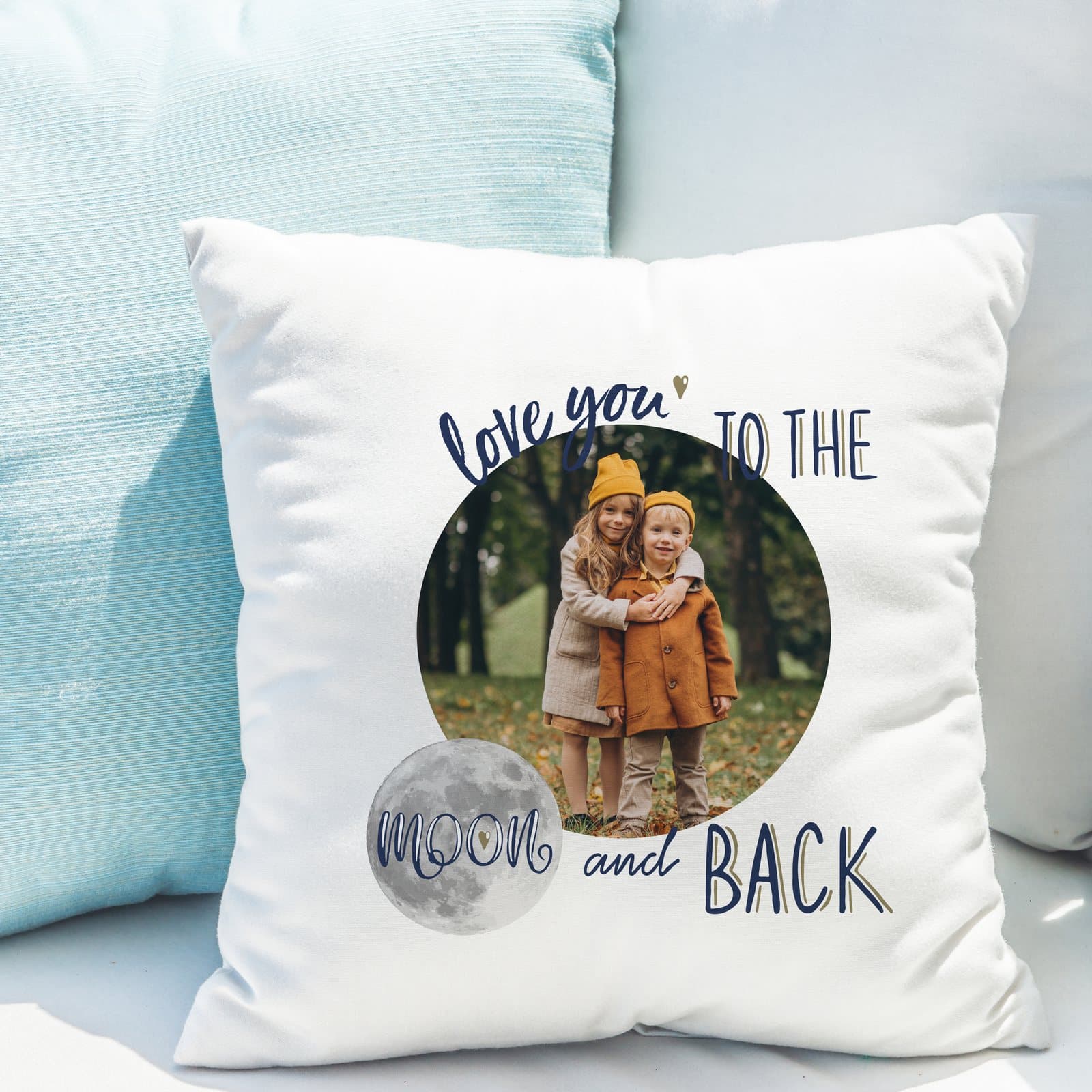 Cushion with a photo at the centre surrounded by the words I love you to the moon and back