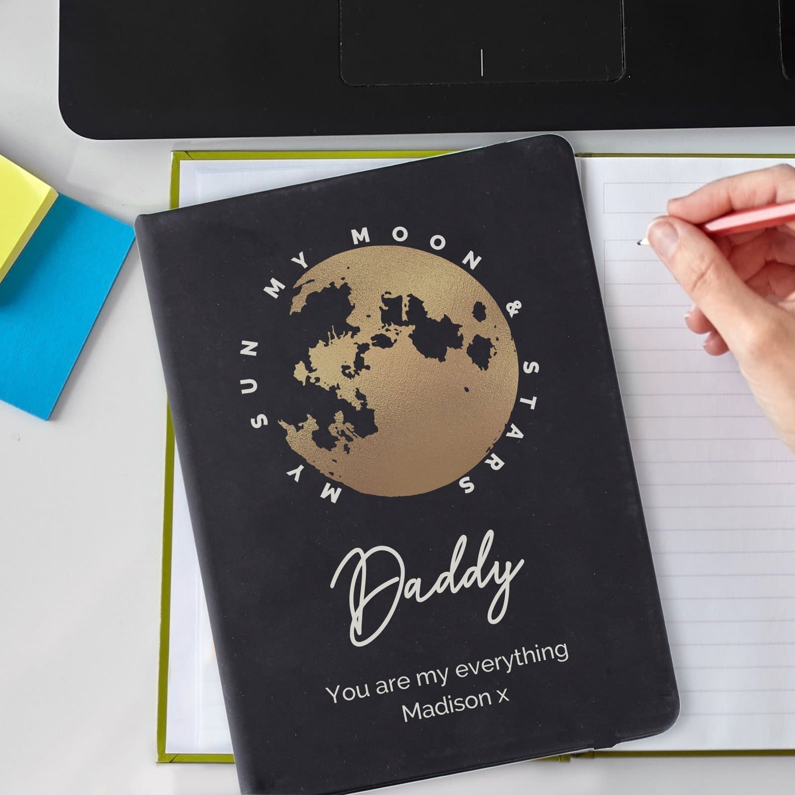 Black hardback notebook with moon and stars design