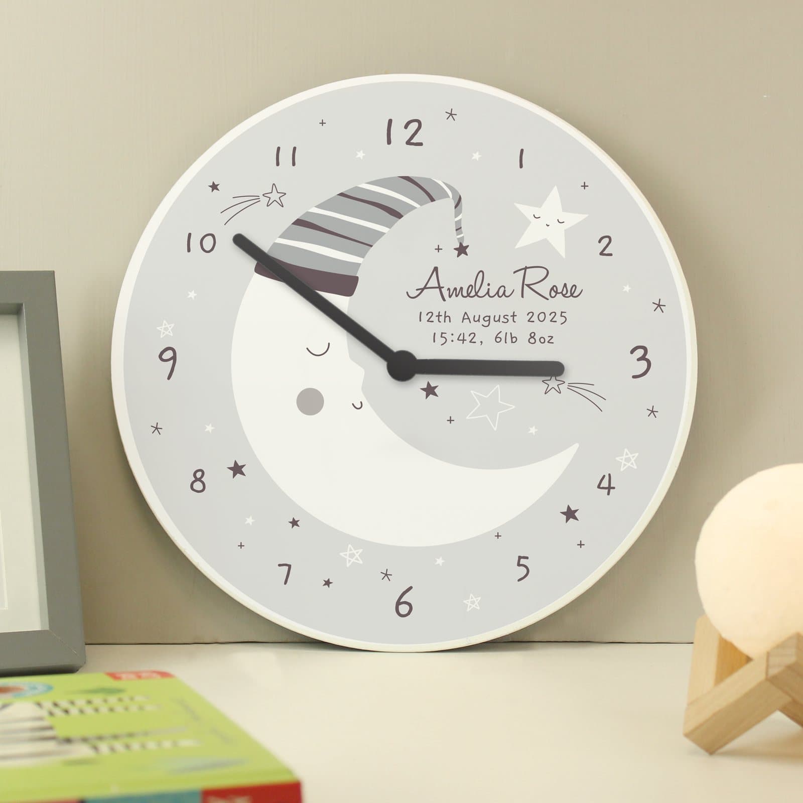 Wooden nursery clock with a crescent moon design and text