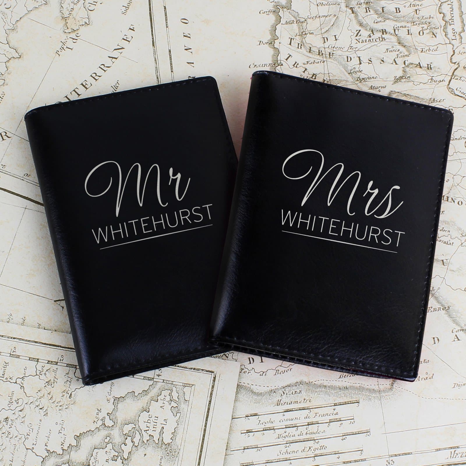 Black leather passport holders marked Mr and Mrs