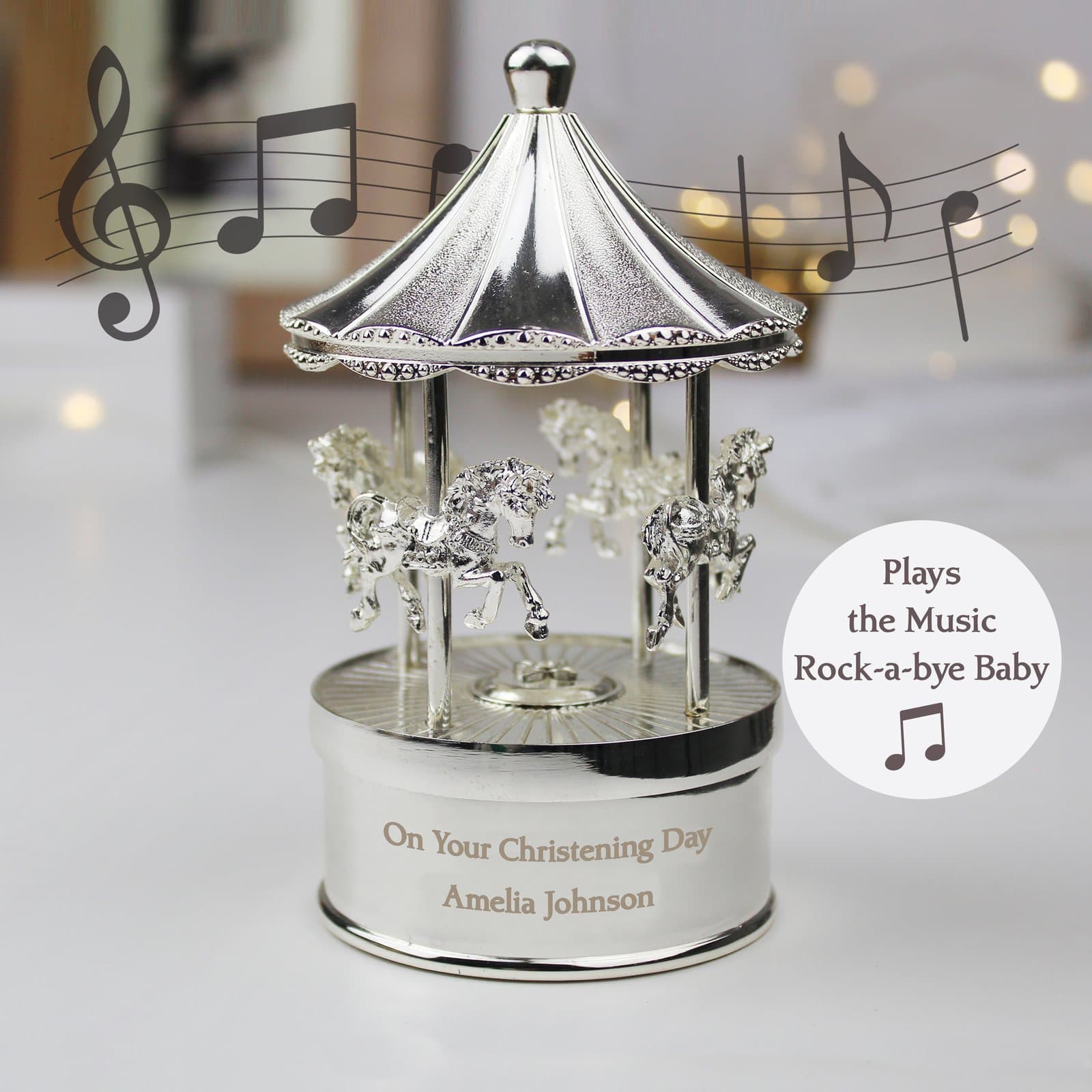 Silver finish musical carousel ornament with horses and an ornate base