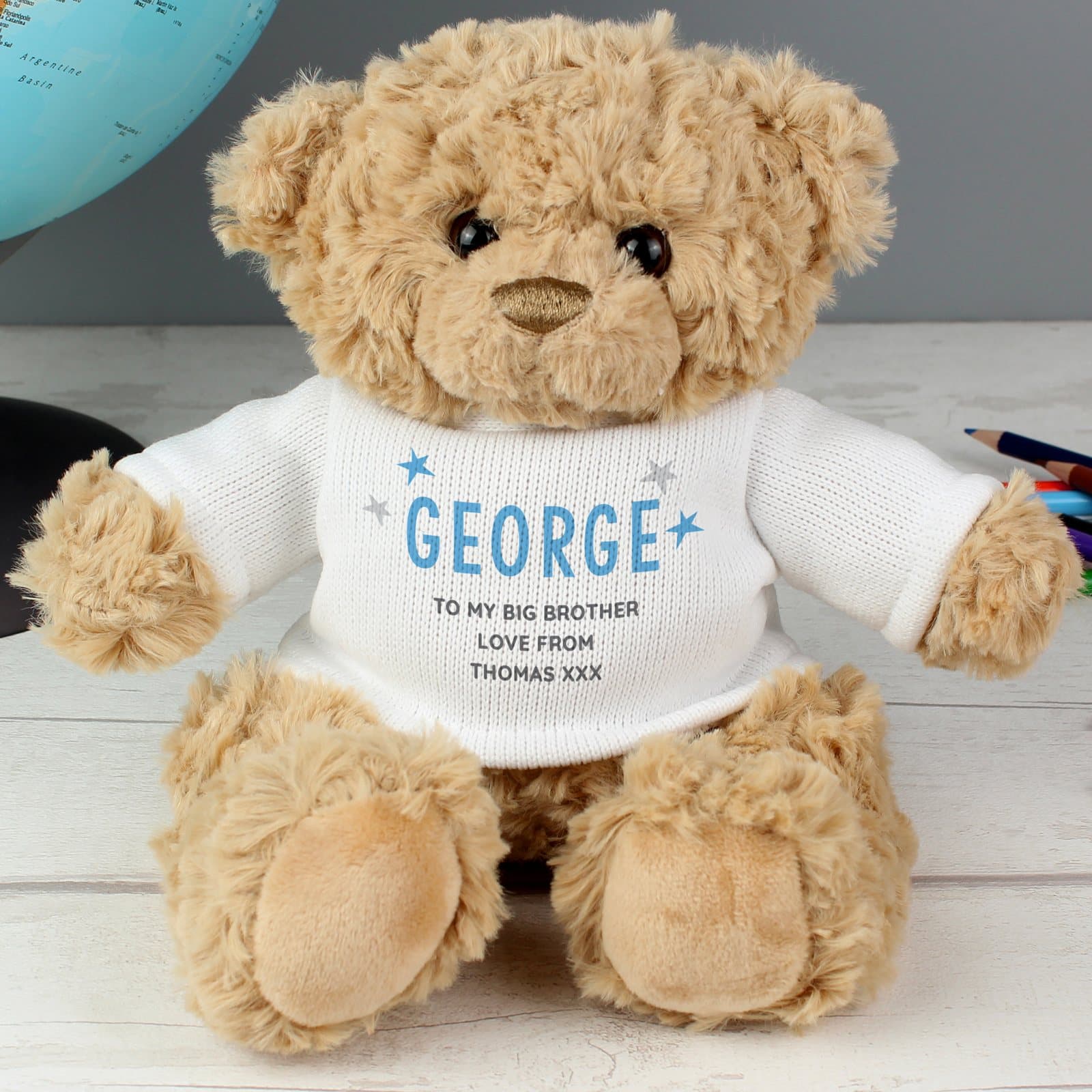 Plush teddy bear in blue or pink