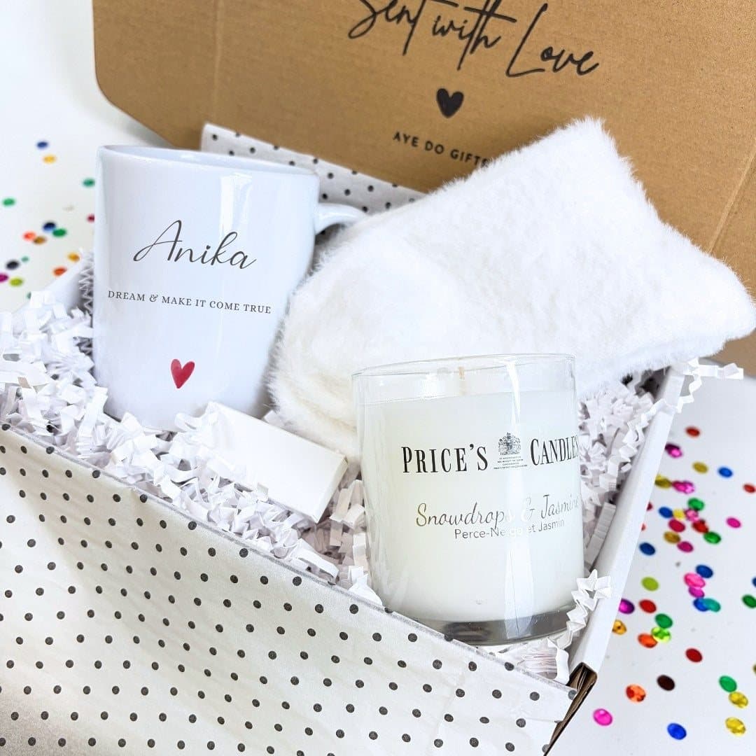 Personalised name mug, fluffy socks, scented candle and box of matches in a gift hamper
