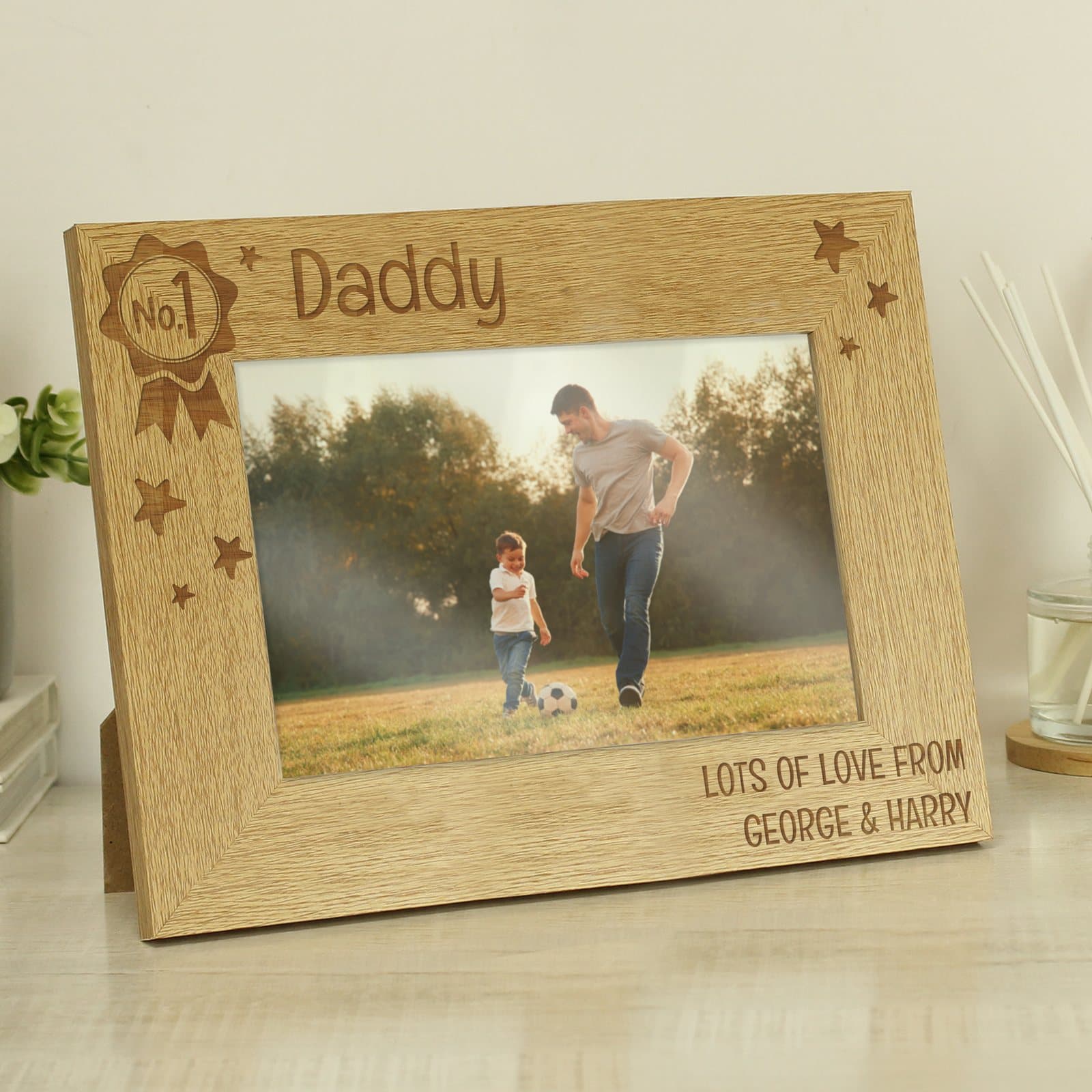 Wooden No.1 landscape photo frame with an engraved rosette in the top left corner