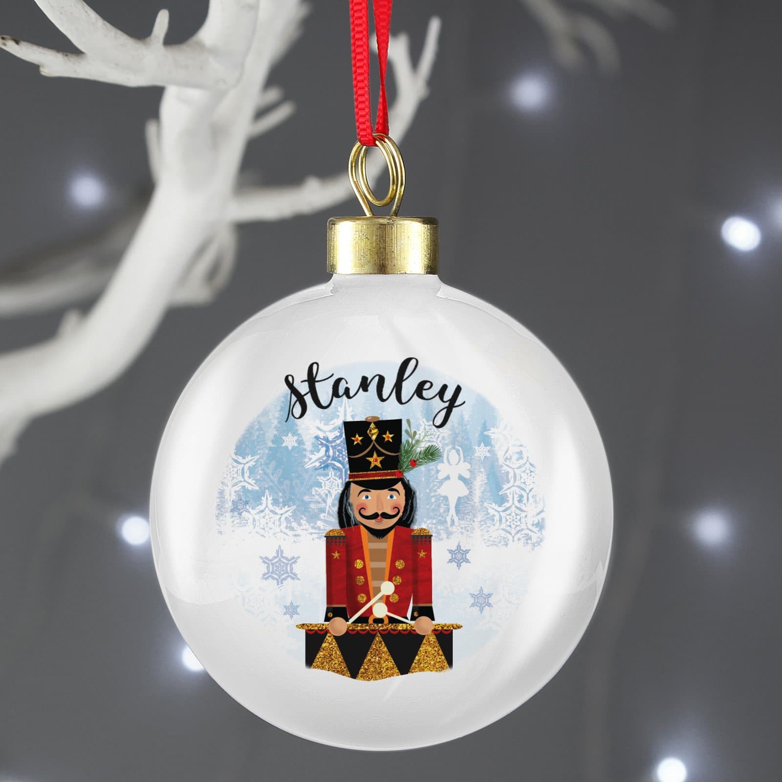 Nutcracker Christmas bauble with a ribbon for hanging on the tree