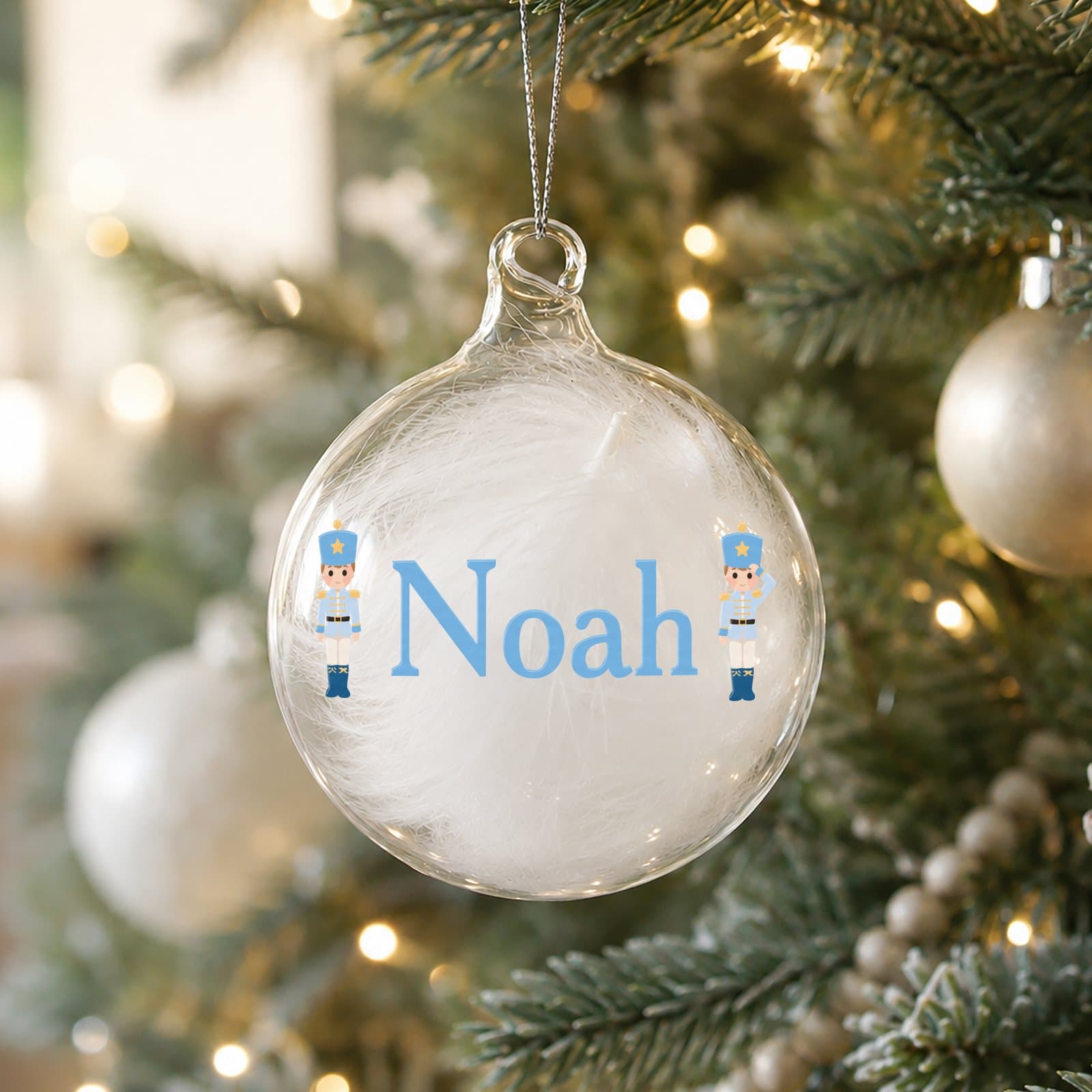 Glass bauble filled with a white feather with a nutcracker design