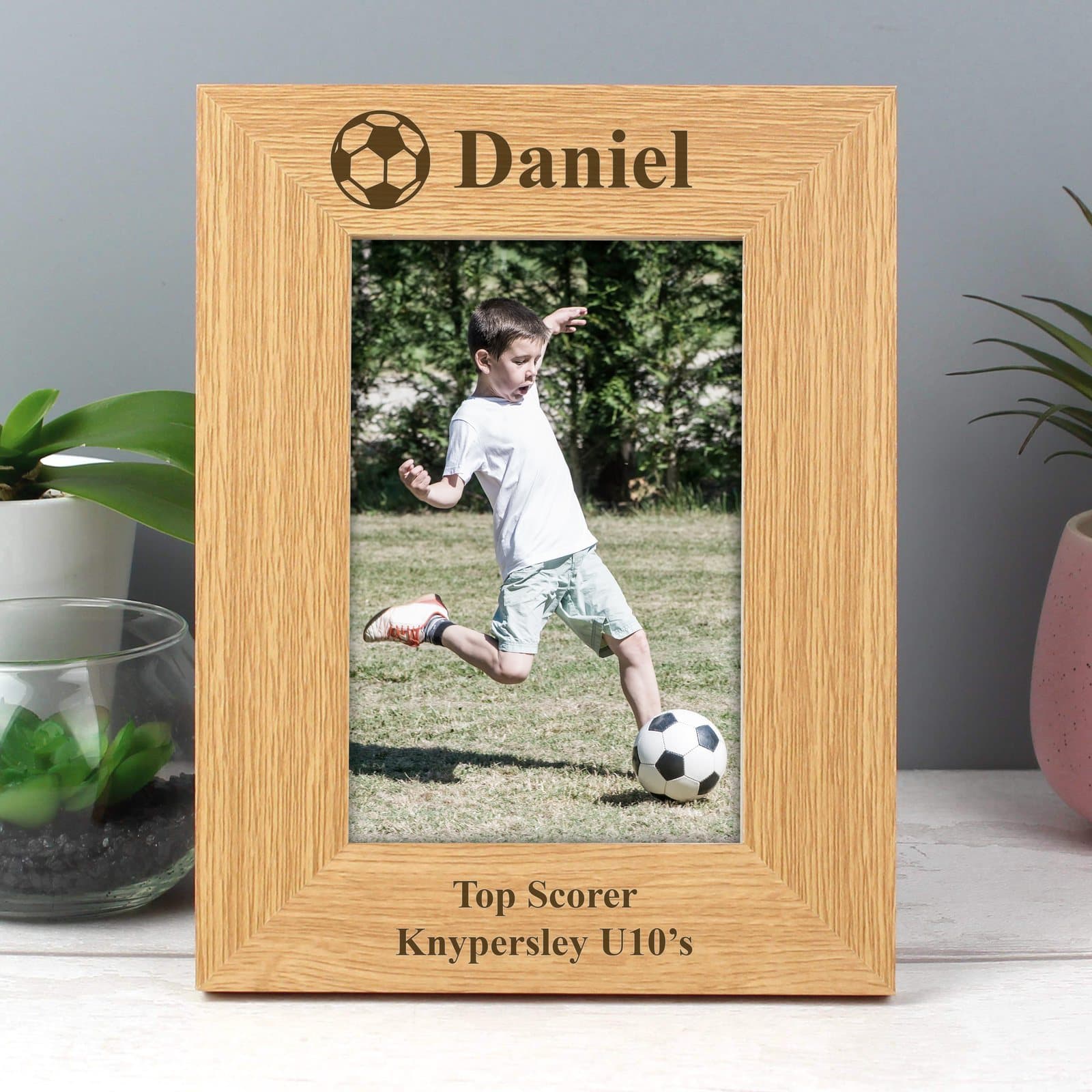 Oak finish football photo frame with a line above and two lines below the photo