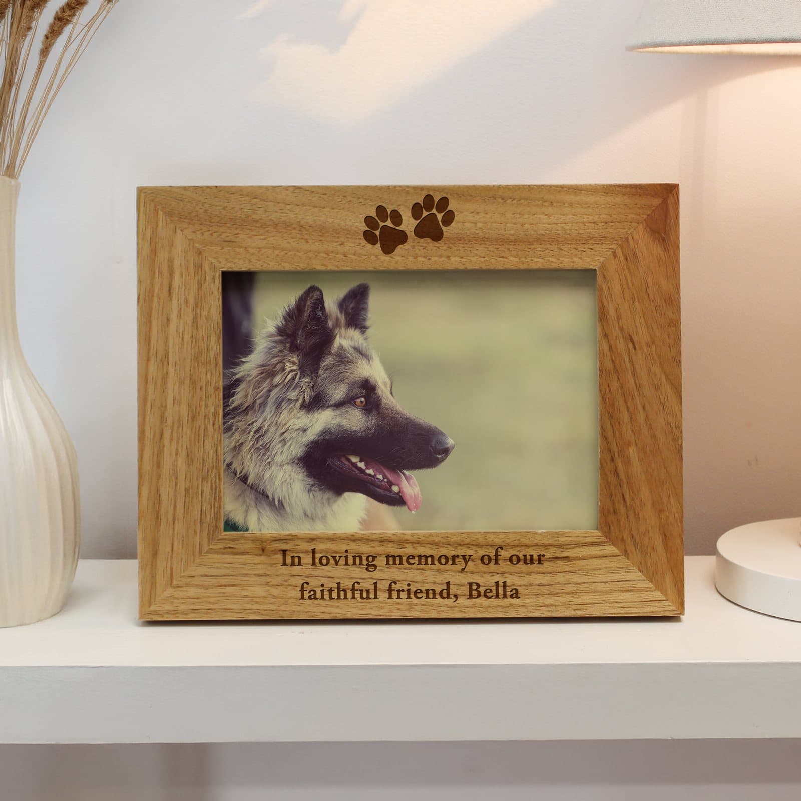 Oak veneer paw prints photo frame with a personalised message below the photo