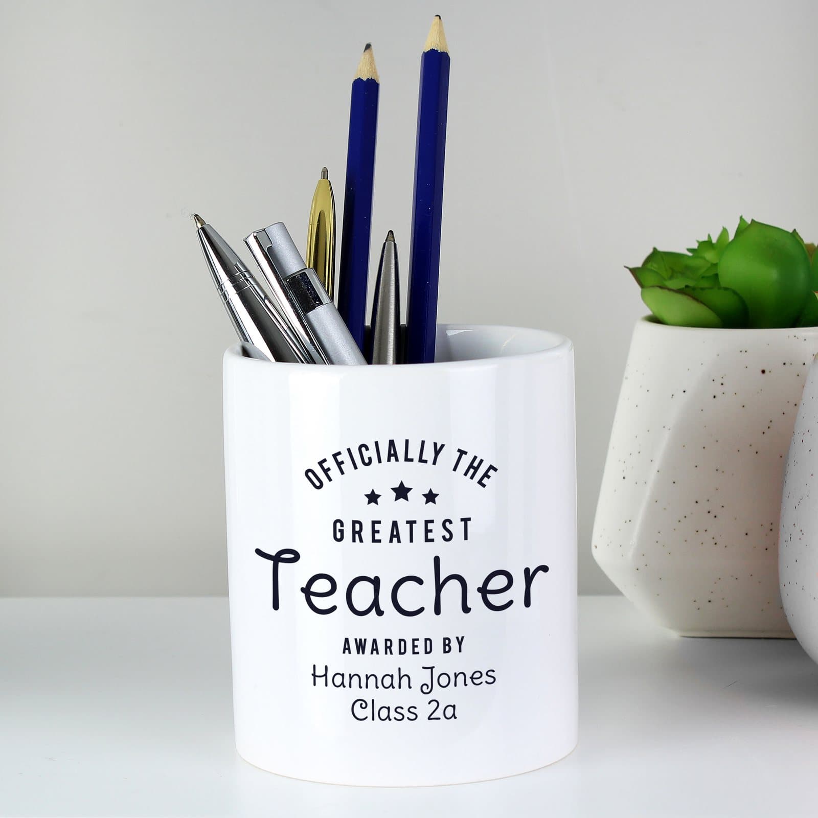 Ceramic storage pot printed with Officially The Greatest and three lines of text