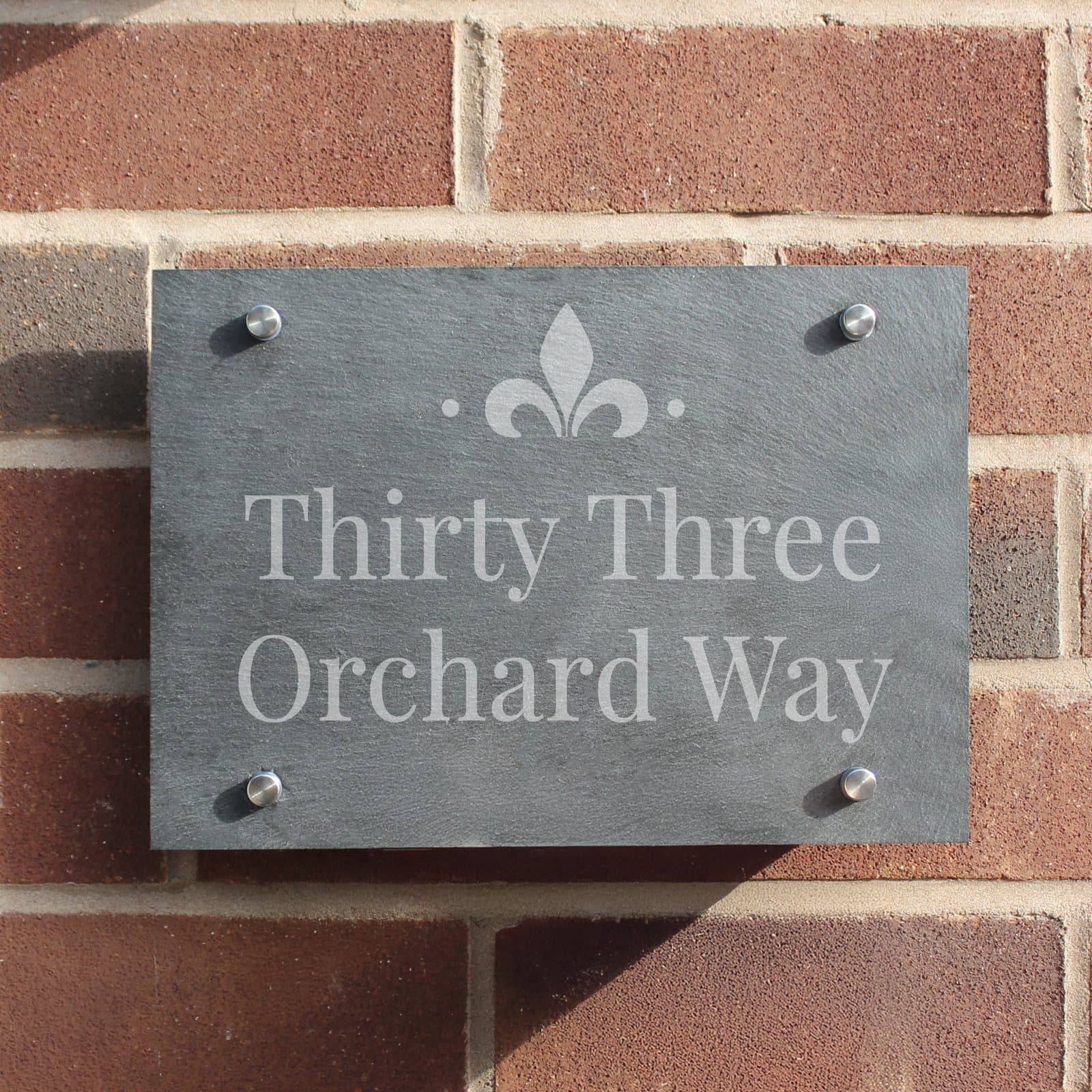 Slate house sign with a stylish motif and two lines of text