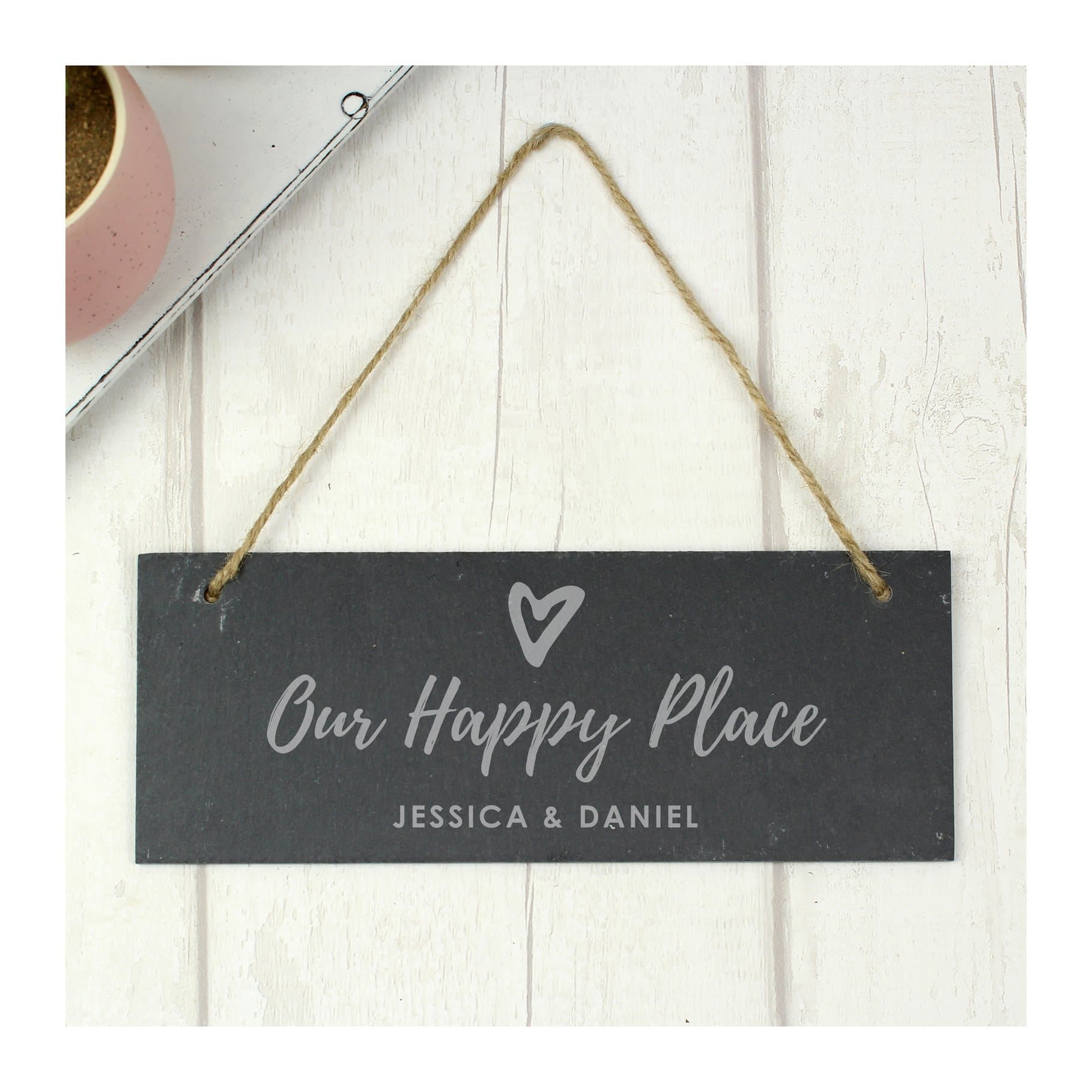 Hanging slate plaque reading Our happy place with a line of text