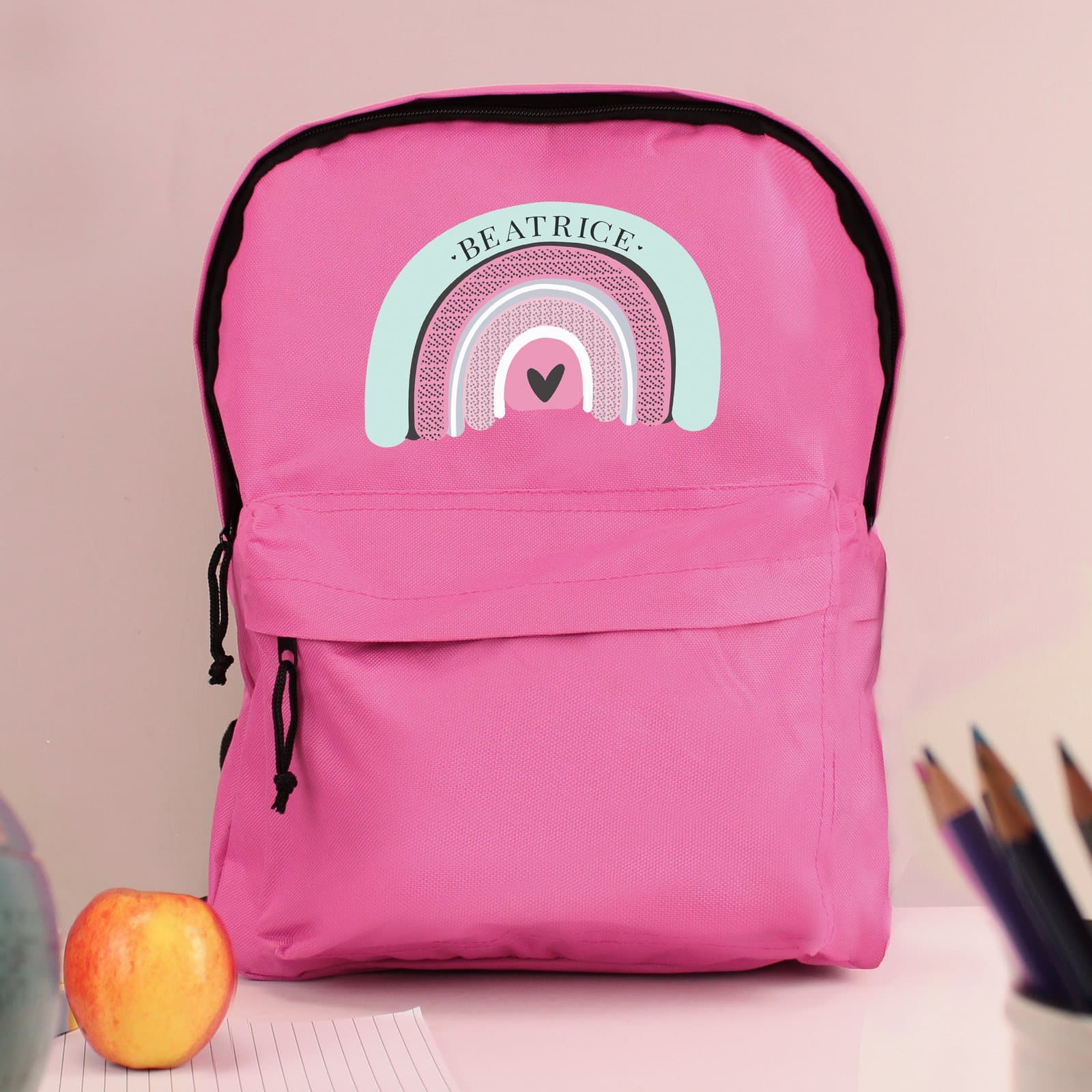 Pink pastel rainbow backpack with a name and a front zip pocket