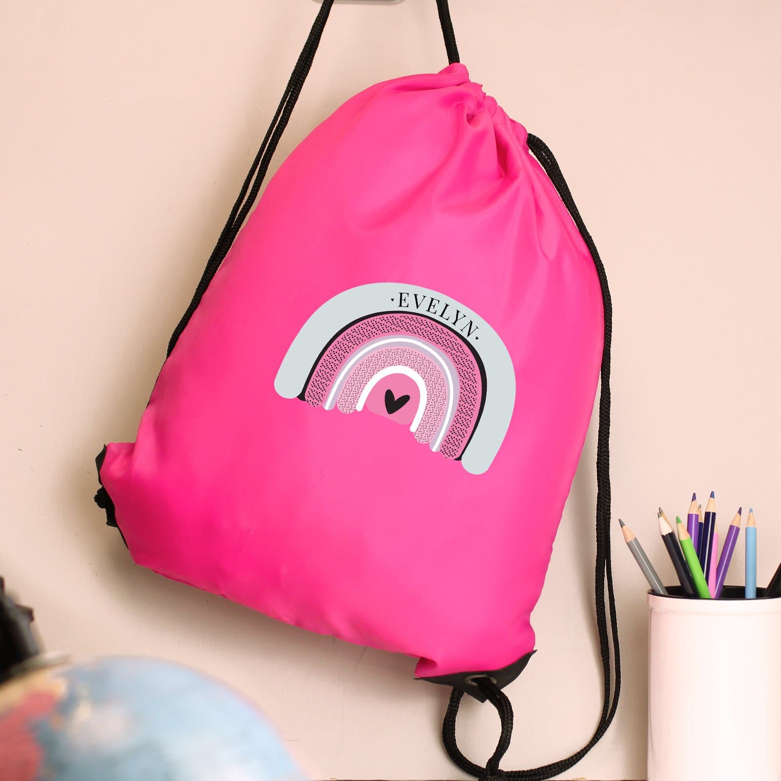 Pink pastel rainbow kit bag with a drawstring and a name
