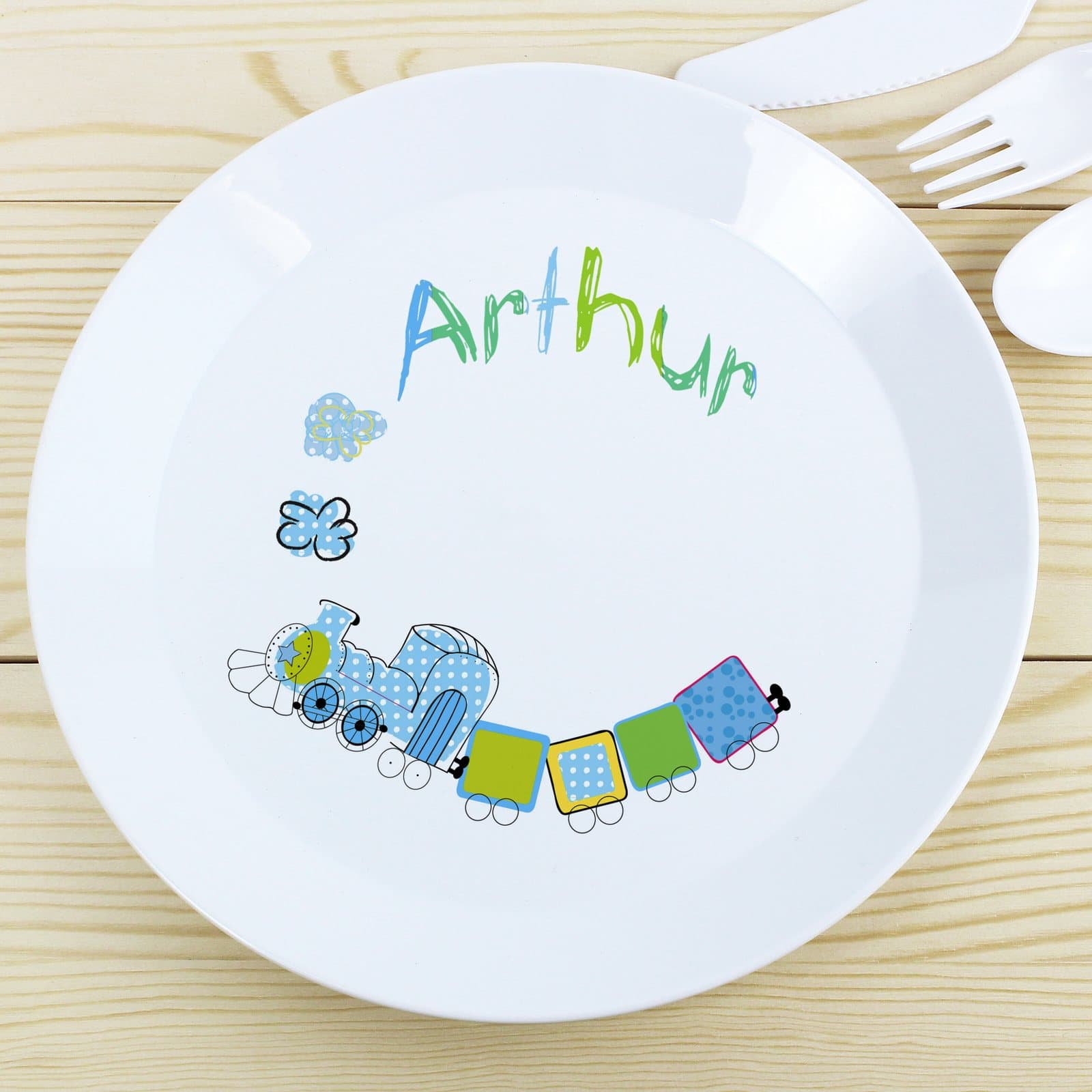 Plastic plate with a patchwork train design and a name