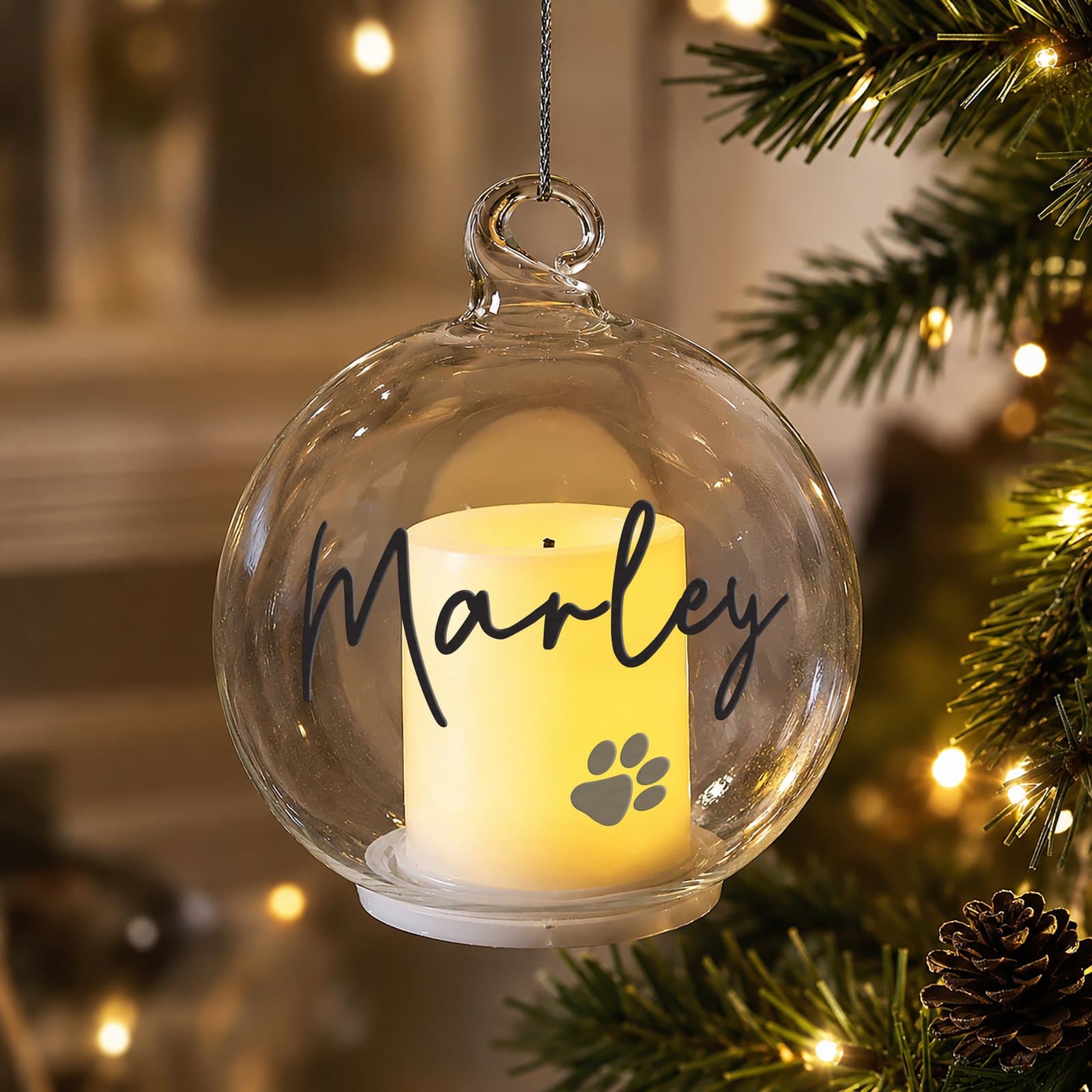 Personalised pawprint memorial glass bauble with a flickering LED candle inside